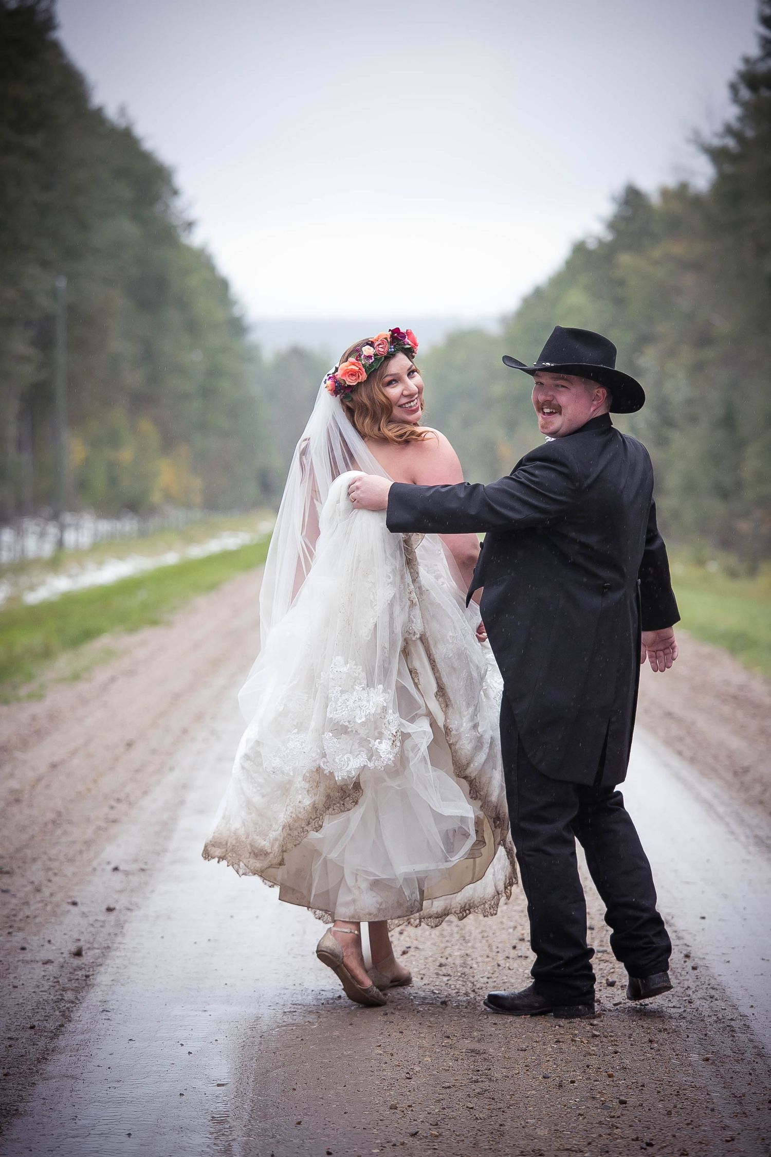 A whimsical sequence of wedding photos showing a couple dancing playfully on a dirt road in the countryside.
