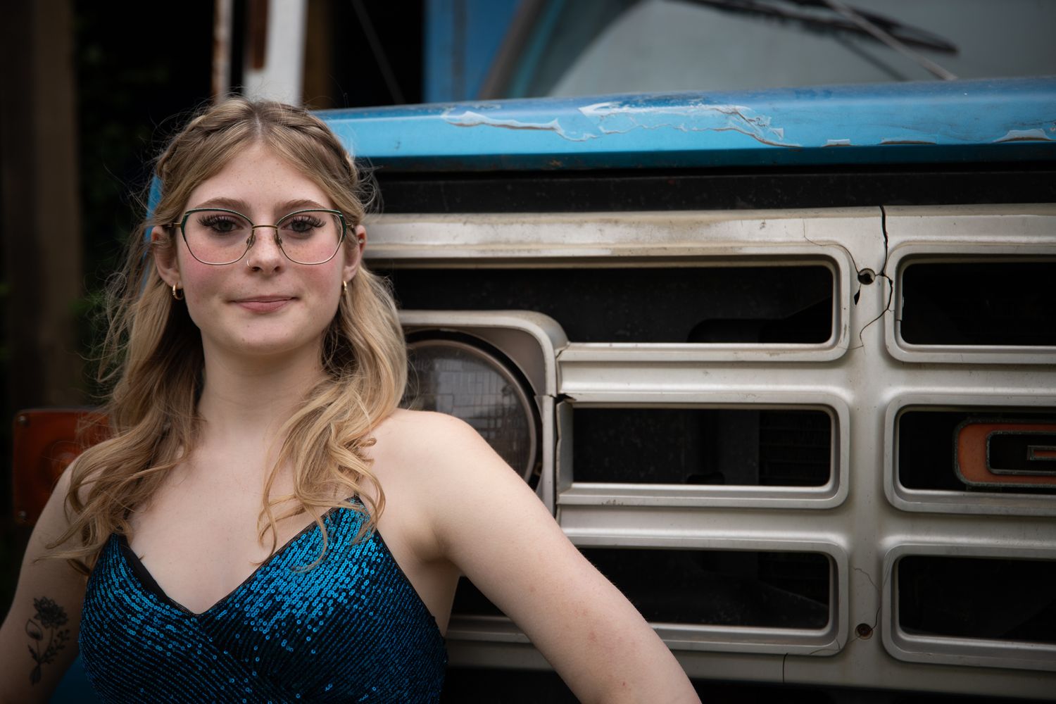 A glamorous photo shoot with vintage buses and a sparkly blue evening gown.