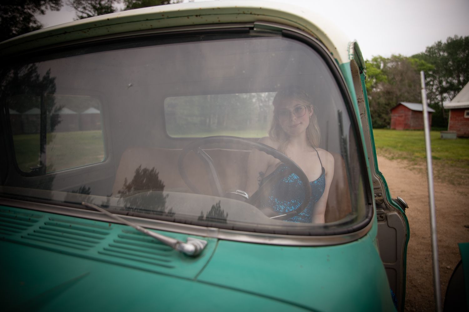 Through the windshield view of a classic mint green vintage car interior.