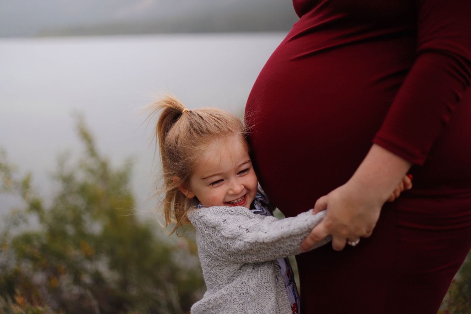 Sweet candid moments between parent and child in outdoor setting.
