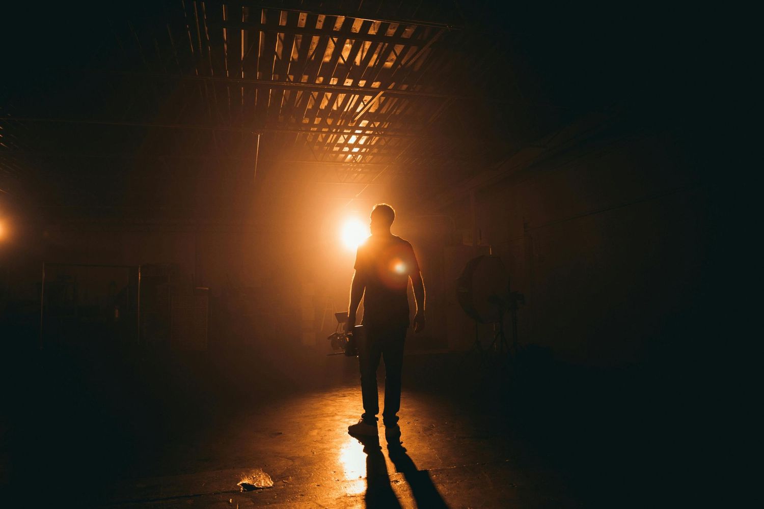 Lowlight photo of a man in his photography studio capturing photos for his business website