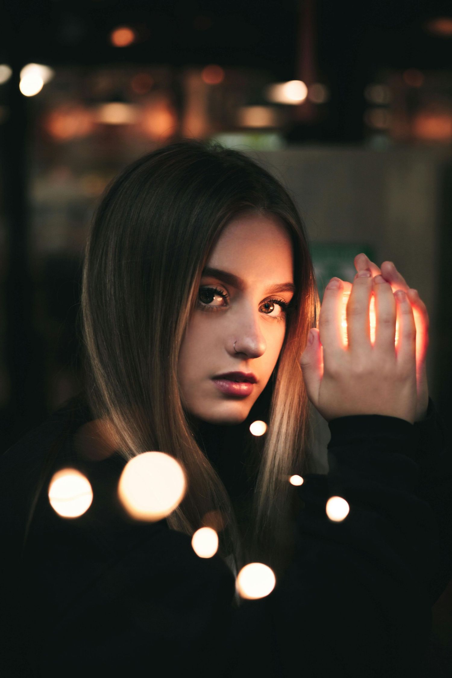 Cinematic night portrait with soft bokeh lights and emotional storytelling photography