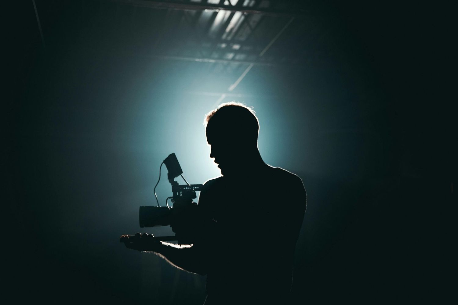 Cool light background and a photographer taking photos in low light.