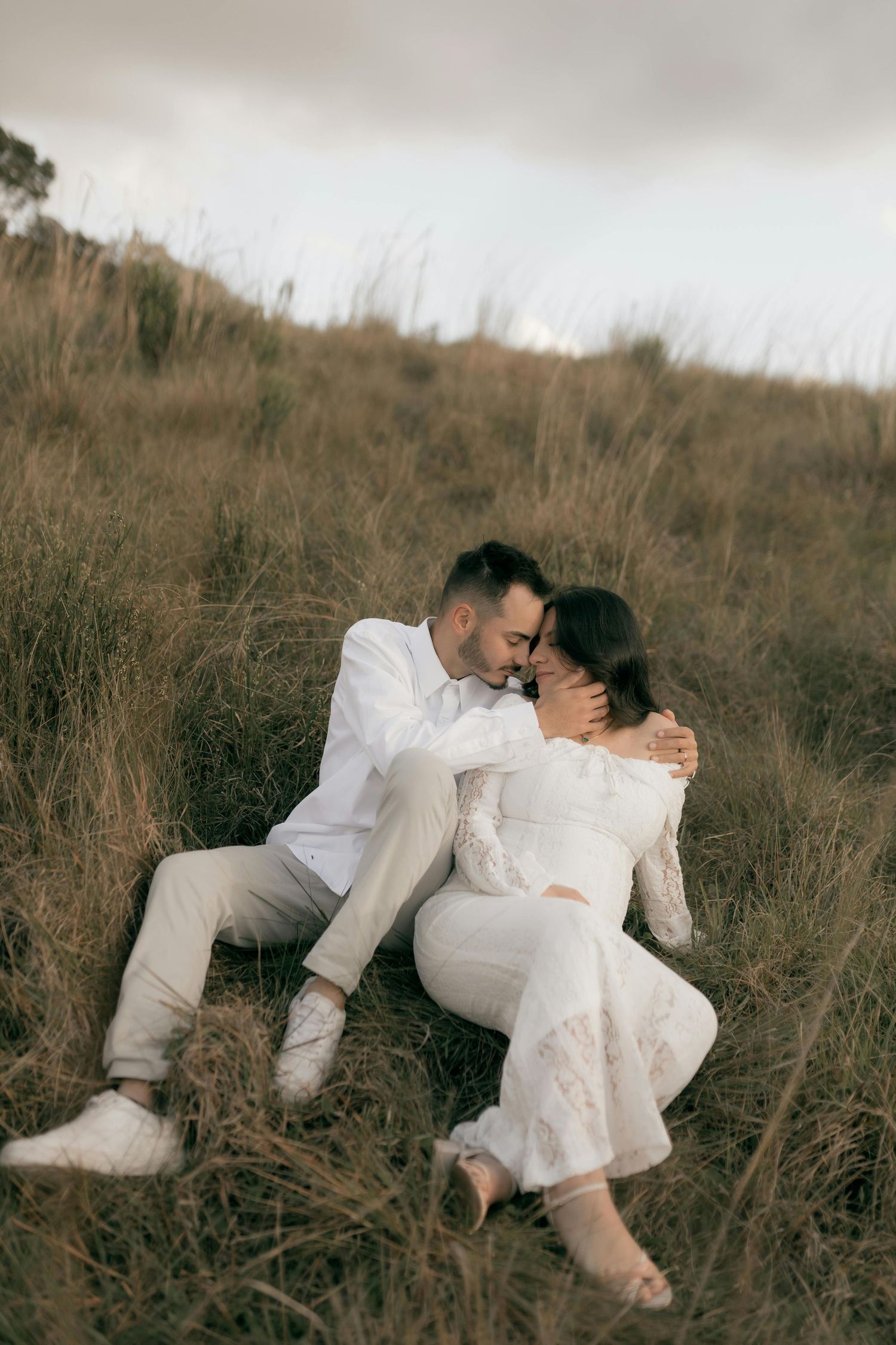 Couple portrait session in a park with a field capturing it with natural light