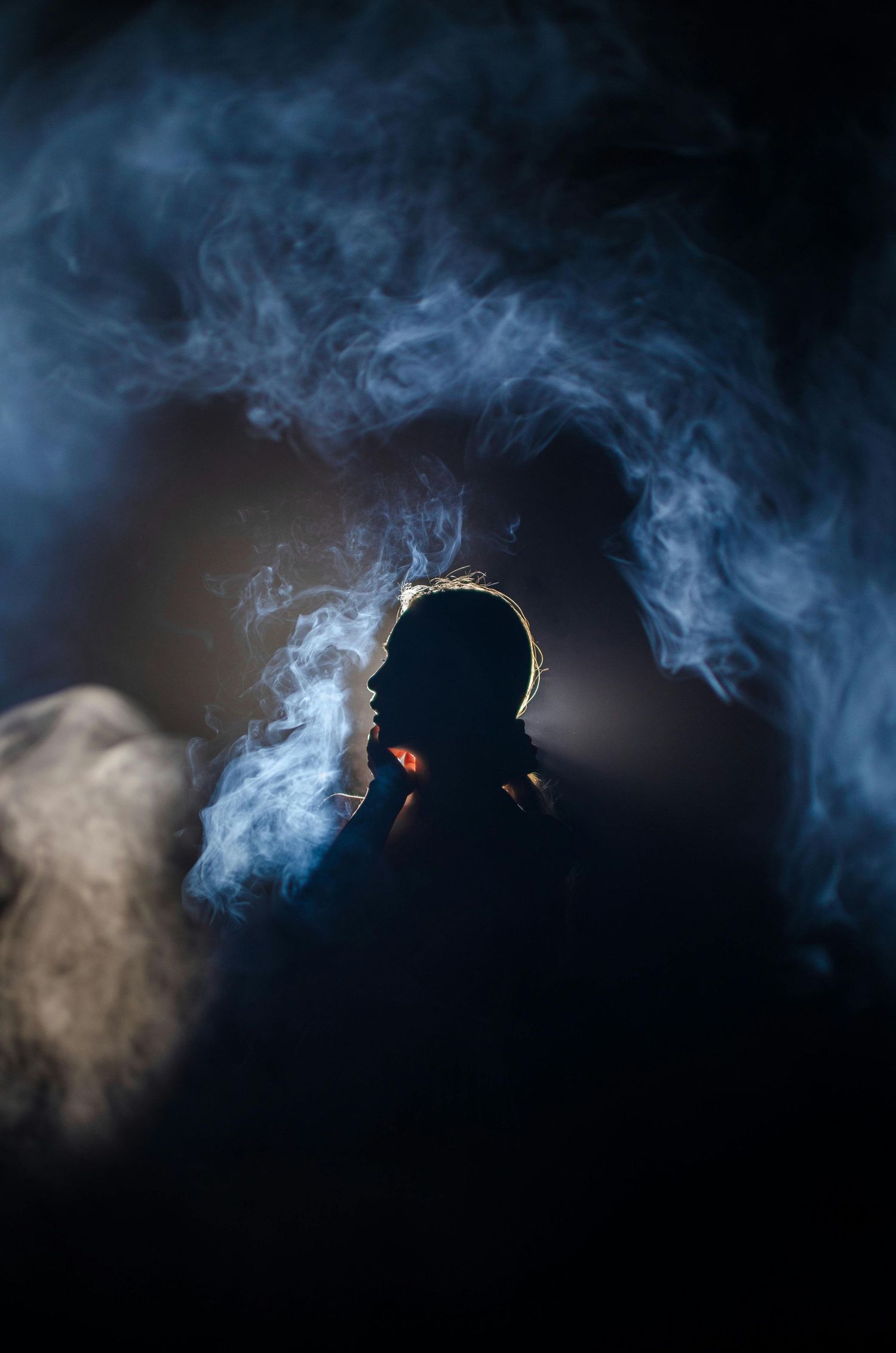 Low light portrait photo with foggy background in a studio