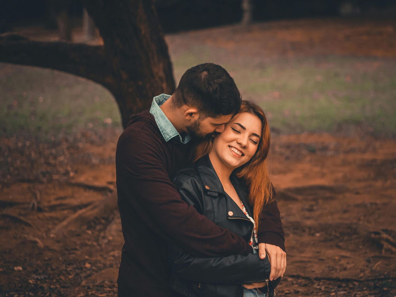 Couple hugging at park posing for a photo shoot capturing real raw moment of love