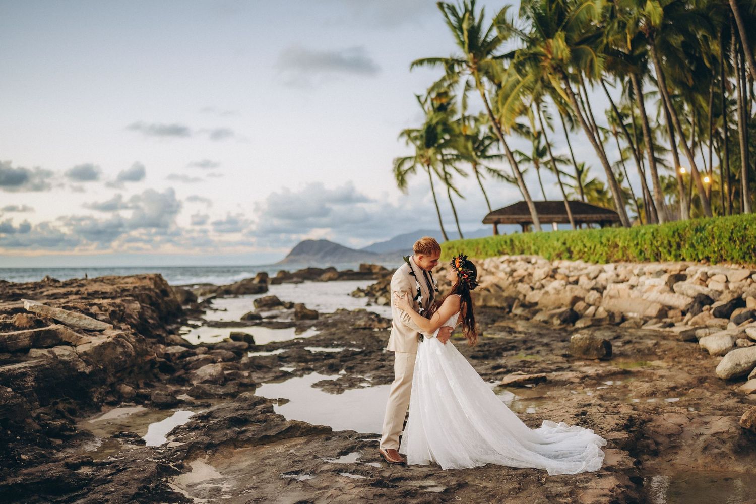 Sunset wedding couple at Four Seasons Resort Oahu at Ko Olina. Storytelling photography with Pacific Ocean and palm trees.