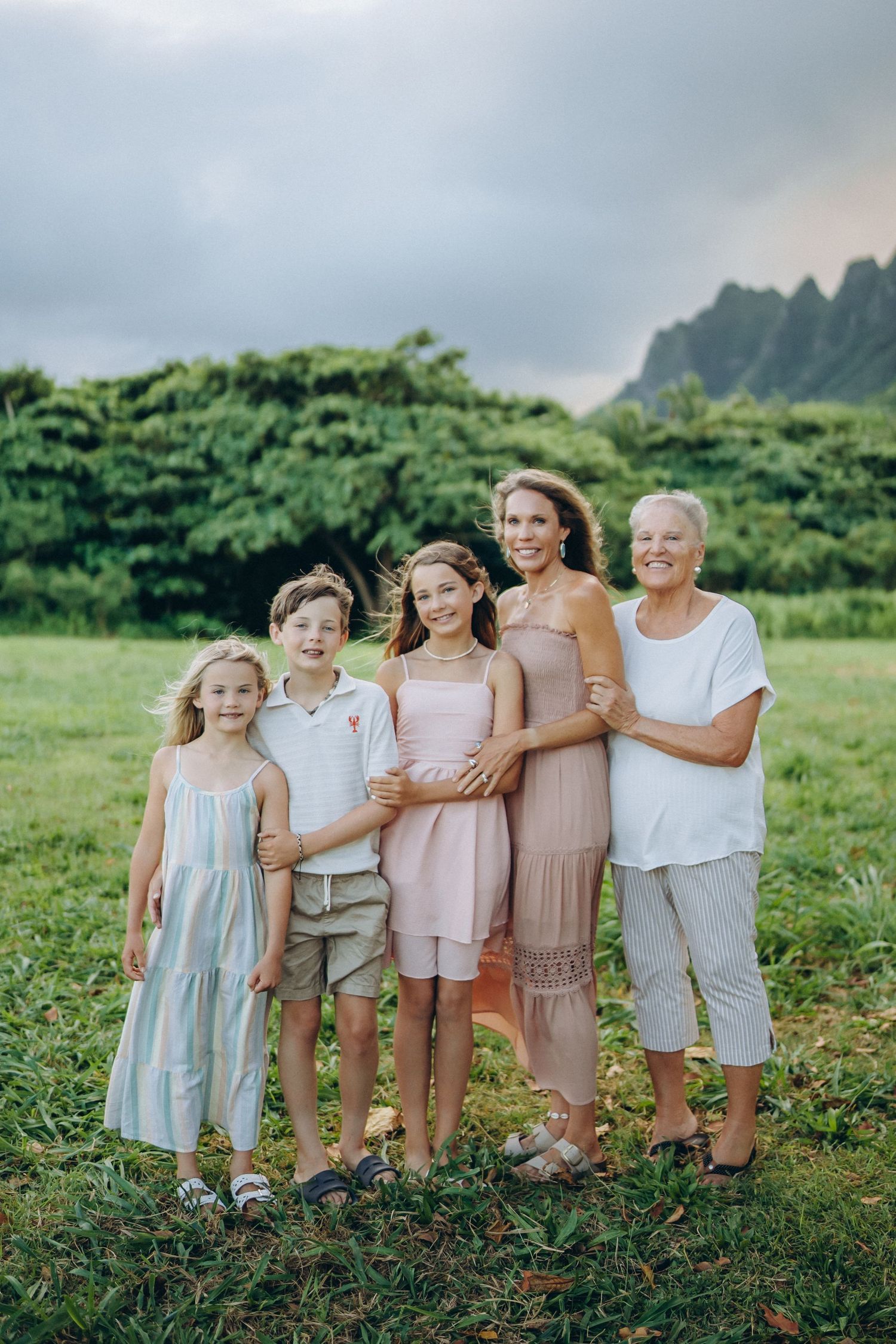 Multi-generational family portrait in a green field, Kualoa Ranch Oahu family photographer, Hawaii