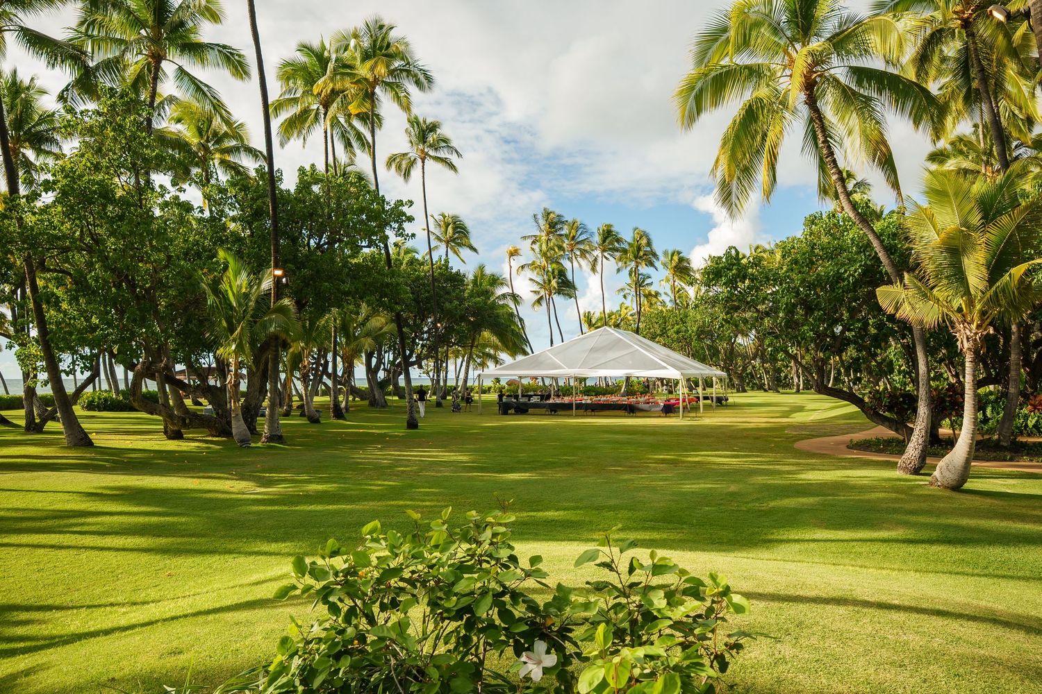 Floral wedding arch at Pohaku Point, Four Seasons Oahu at Ko Olina. Oceanfront wedding ceremony setup with tropical decor.
