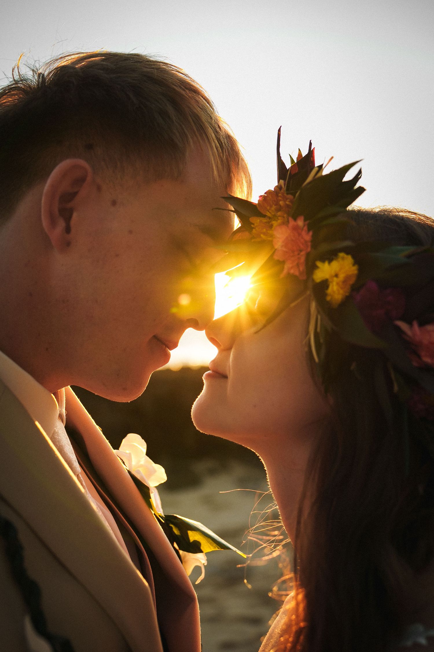 Romantic portrait of a wedding couple with palm trees and ocean backdrop at Four Seasons Ko Olina.