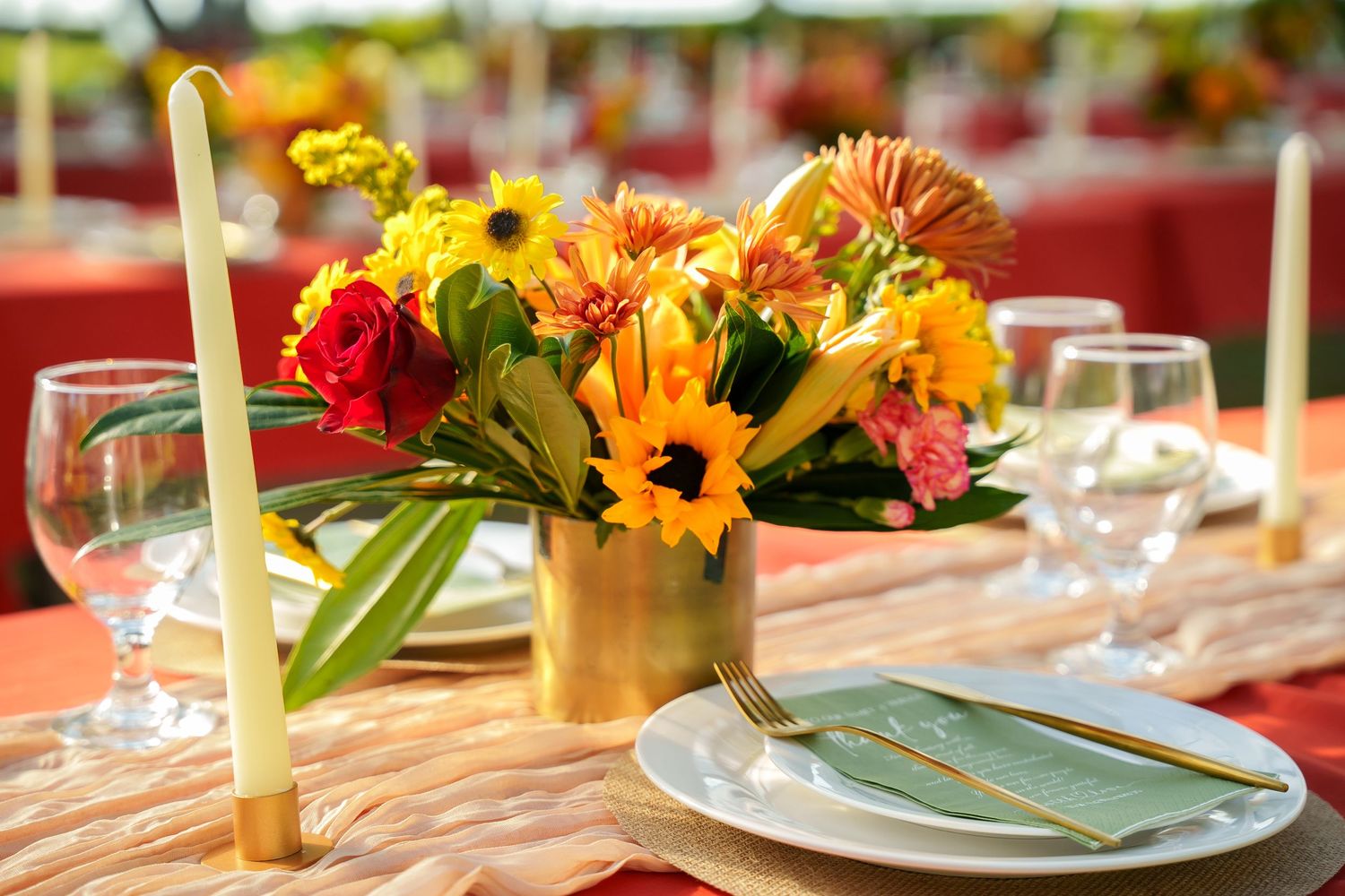 Elegant wedding table decor at Ko Olina. Tropical floral centerpiece with yellow flowers and candles for an Oahu reception.