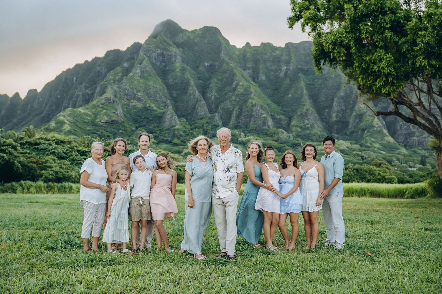 Three-generation family portrait with grandparents and grandchildren at Kualoa Ranch, Oahu family photographer