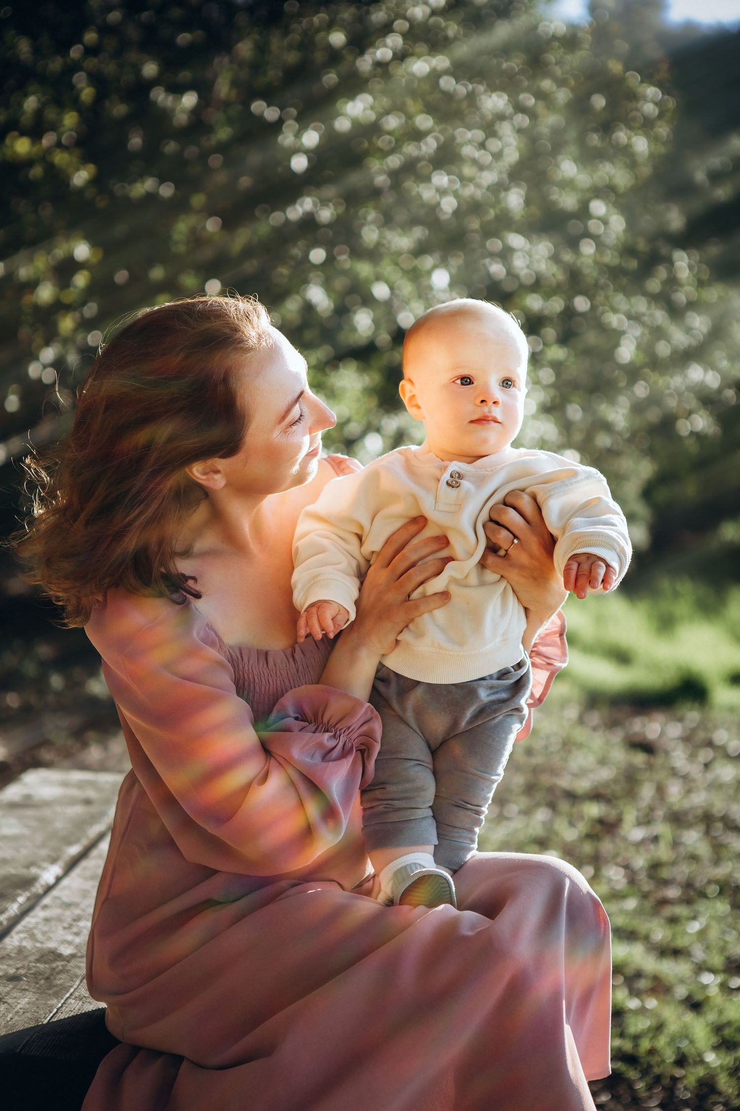 Mother holding baby in soft sunlight — lifestyle family photographer in Denver, Colorado