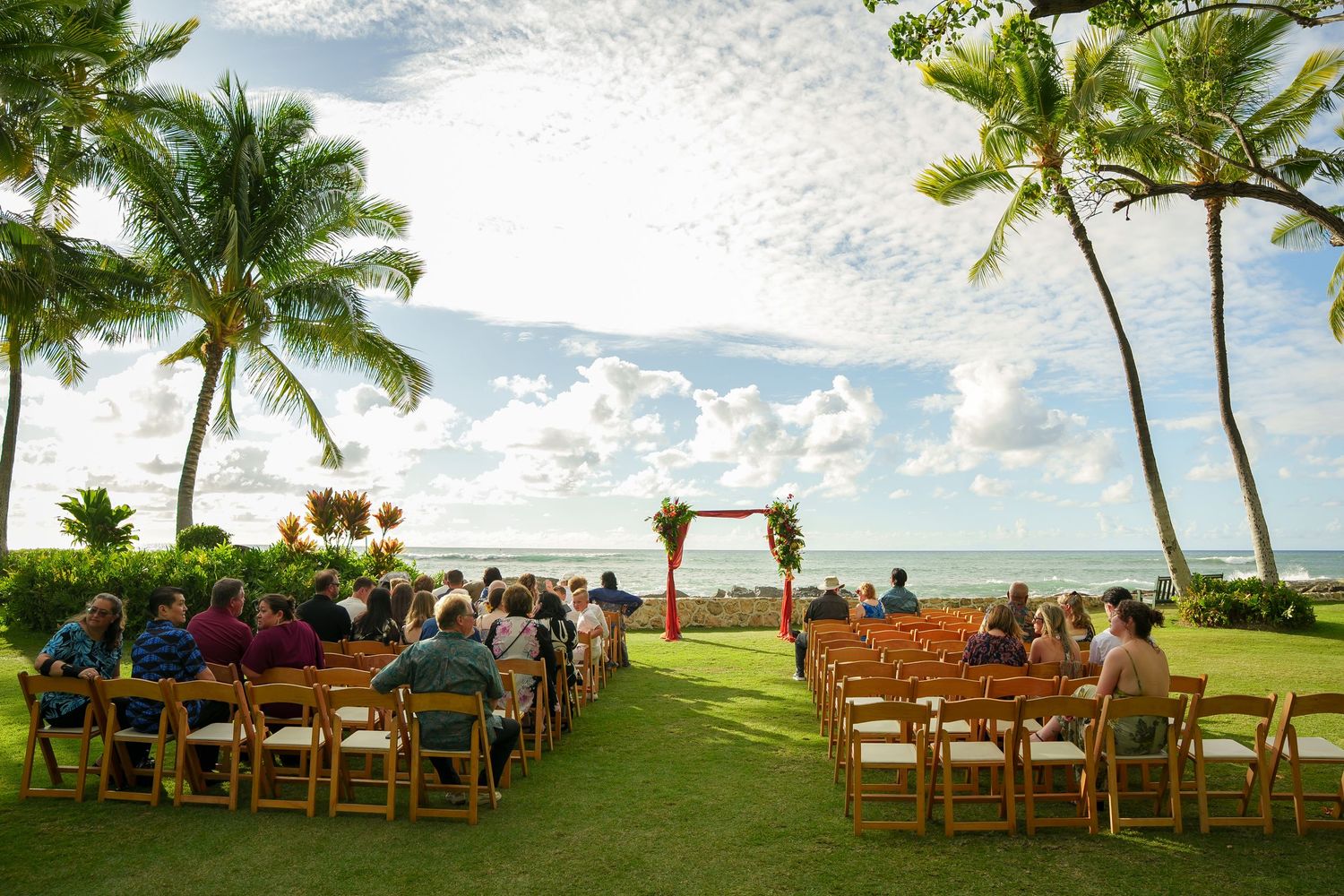 Outdoor wedding ceremony on the Ocean Lawn at Four Seasons Resort Oahu at Ko Olina. Cinematic storytelling of a Hawaii destination wedding.