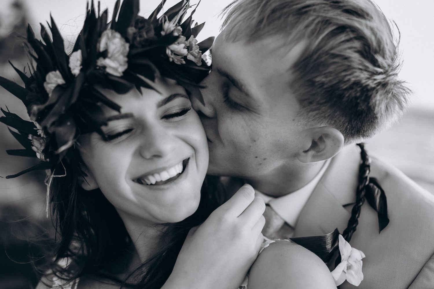 Emotional black and white wedding portrait at Four Seasons Resort Oahu. Bride wearing a traditional Hawaiian Haku Lei at Ko Olina lagoons. C