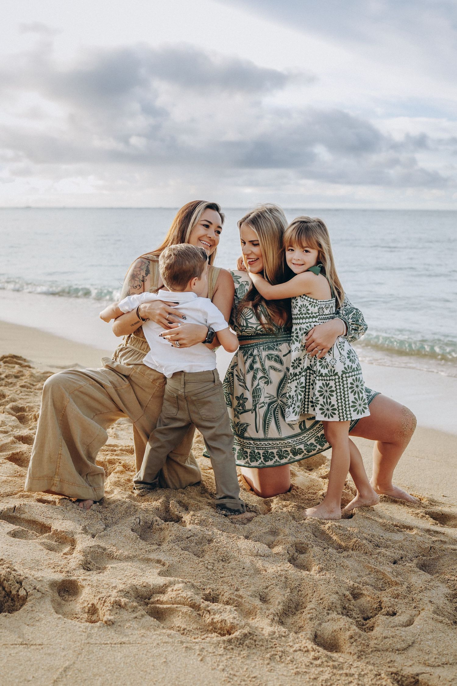 A 2 mom family. joyful moments together on a sandy beach near Hilton Hawaiian Village