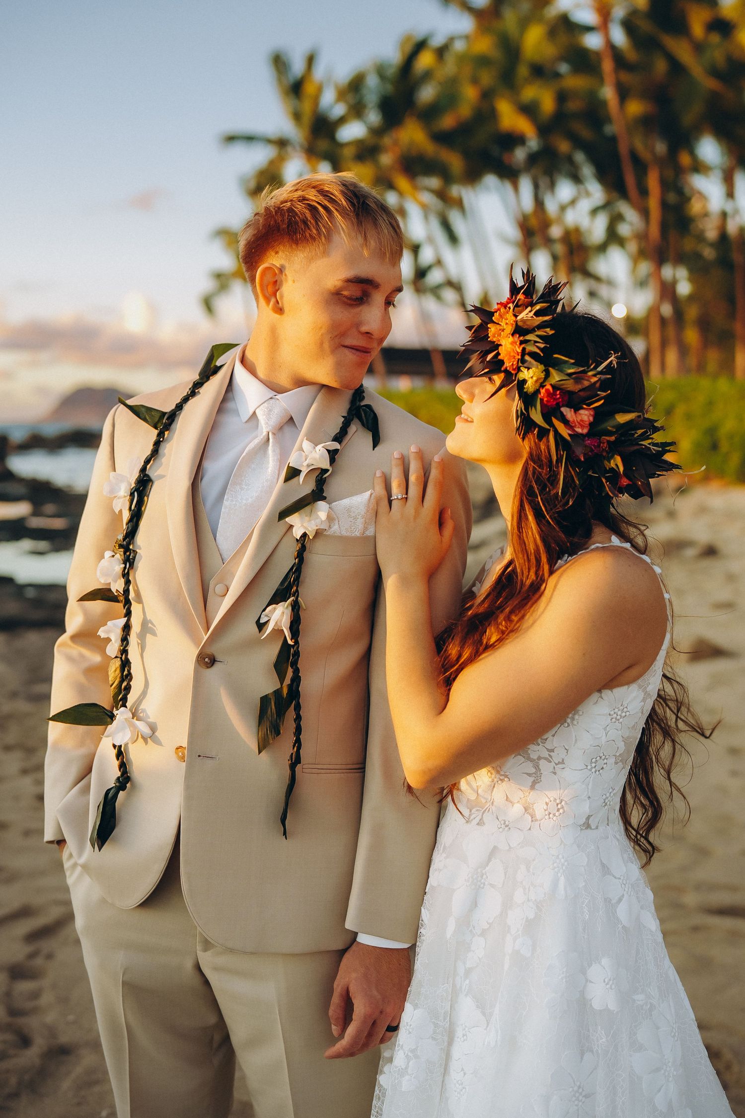 Romantic portrait of a wedding couple with palm trees and ocean backdrop at Four Seasons Ko Olina.