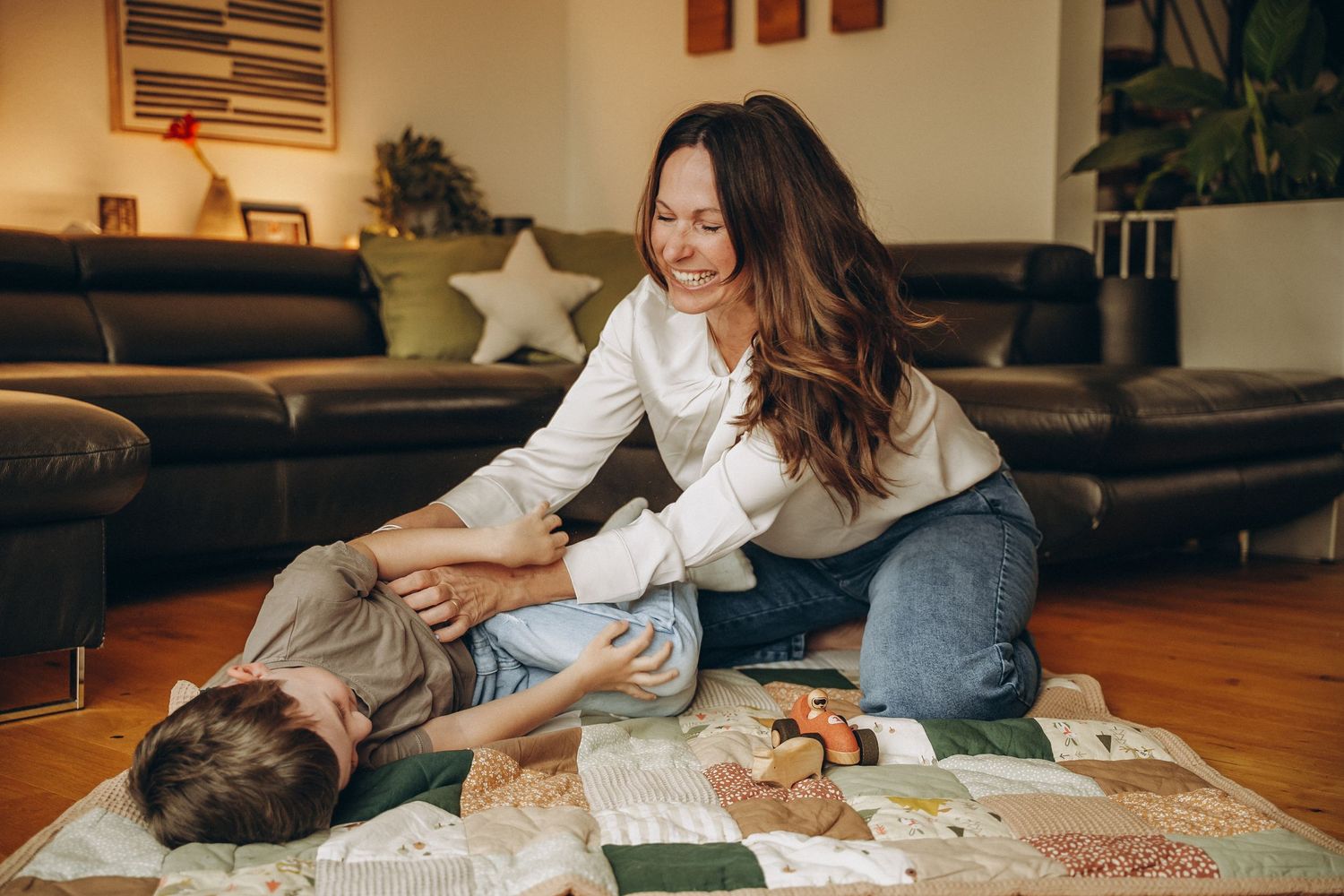 Mom playing with toddler on the floor at home — in-home lifestyle family photography in Boulder, Colorado