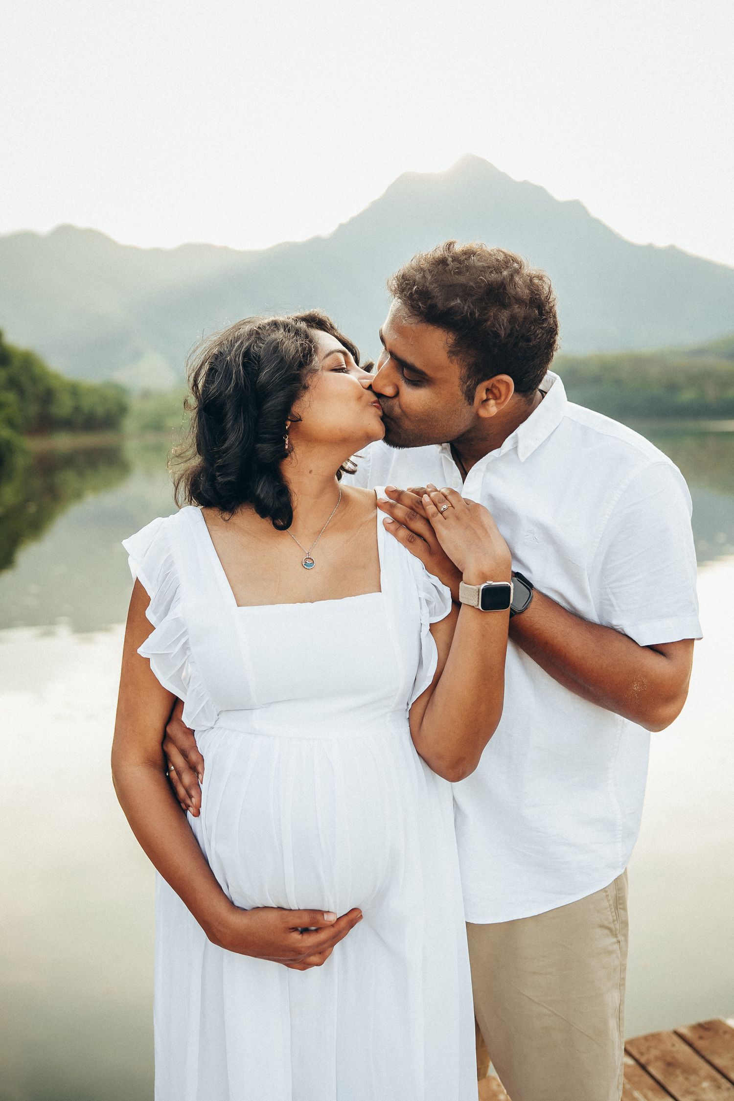 Secret Beach family photoshoot, Oahu. A romantic moment between a couple during a session at Kualoa Ranch. Professional photography.