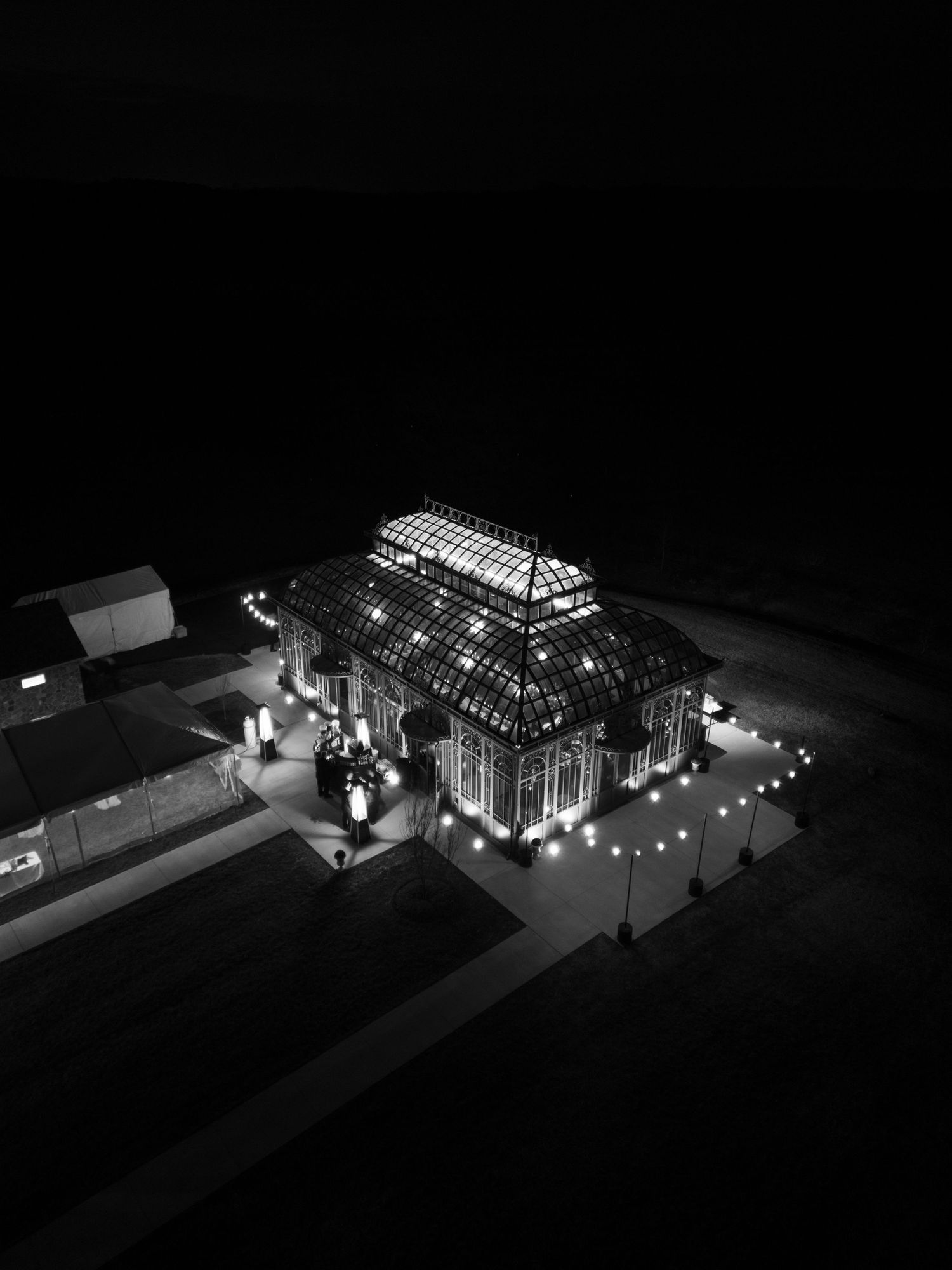 Architectural model showing illuminated building structures at night with glowing lights and transparent walls.