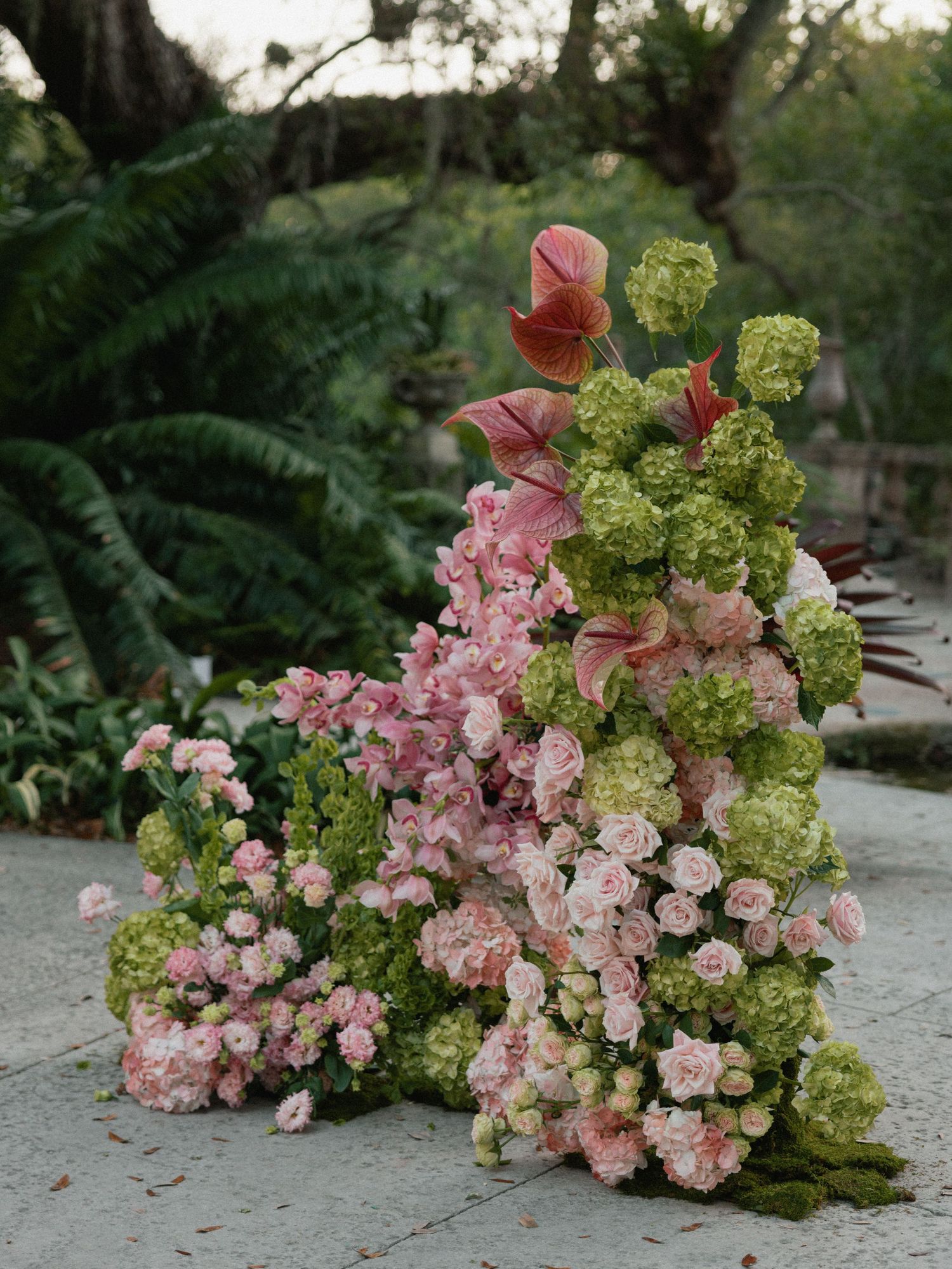 A sequence of photos showing pink and green hydrangea flowers arranged on a stone surface in varying compositions.