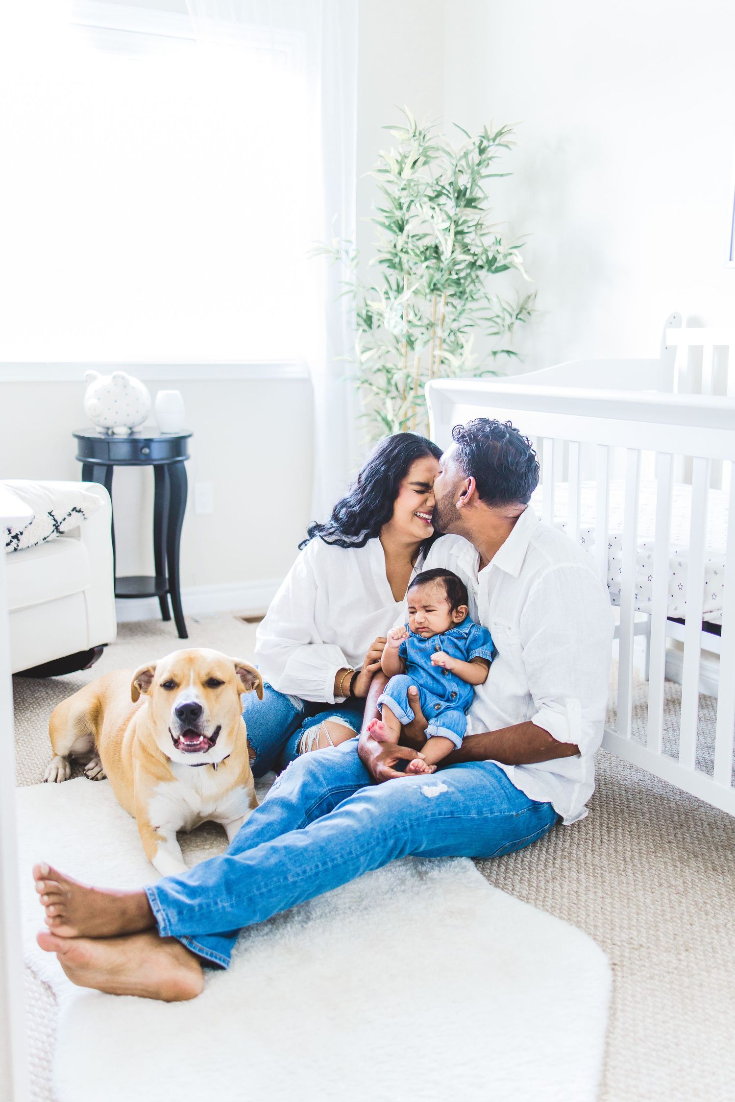 A family enjoying their moment with their newborn in this family newborn session in GTA