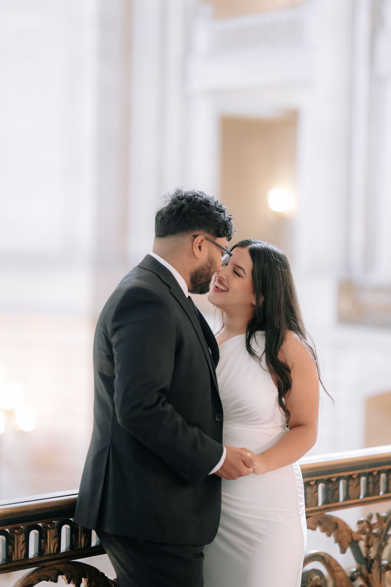 Romantic couple portrait at San Francisco City Hall dome interior
