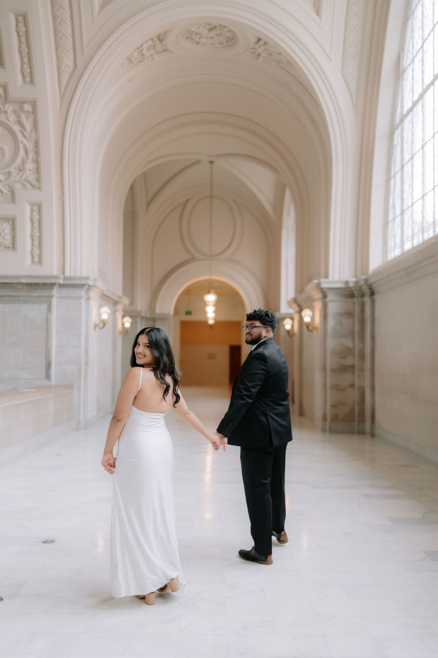 Romantic couple portrait at San Francisco City Hall dome interior