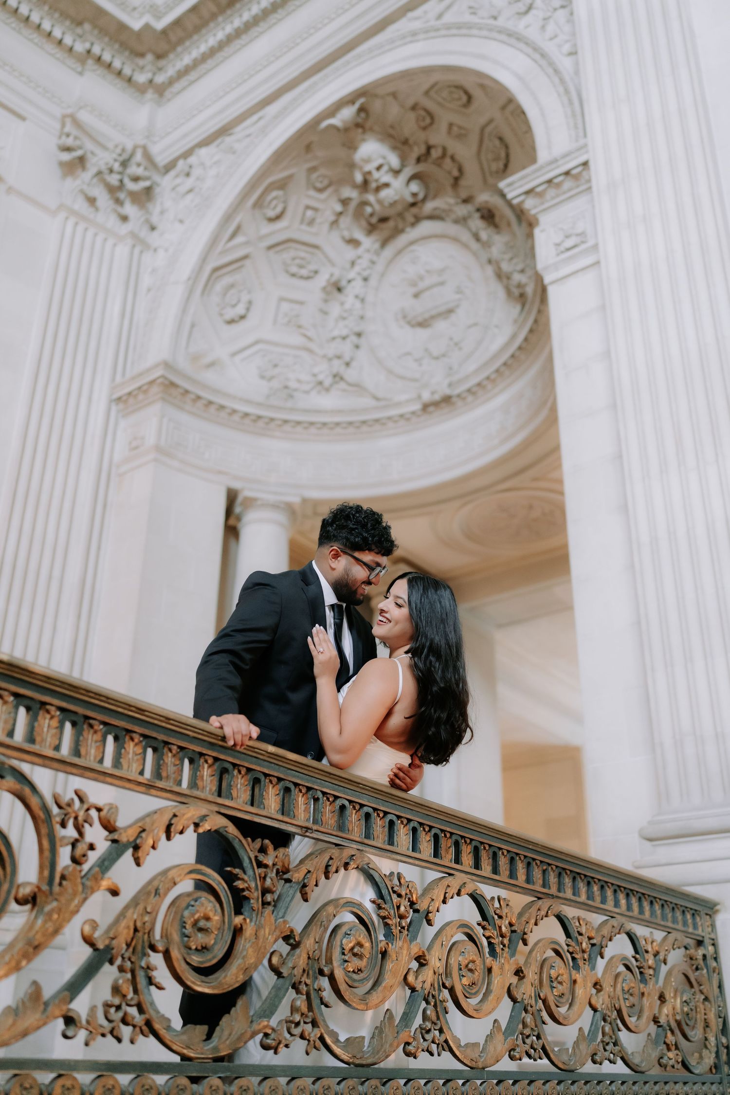 Romantic couple portrait at San Francisco City Hall dome interior