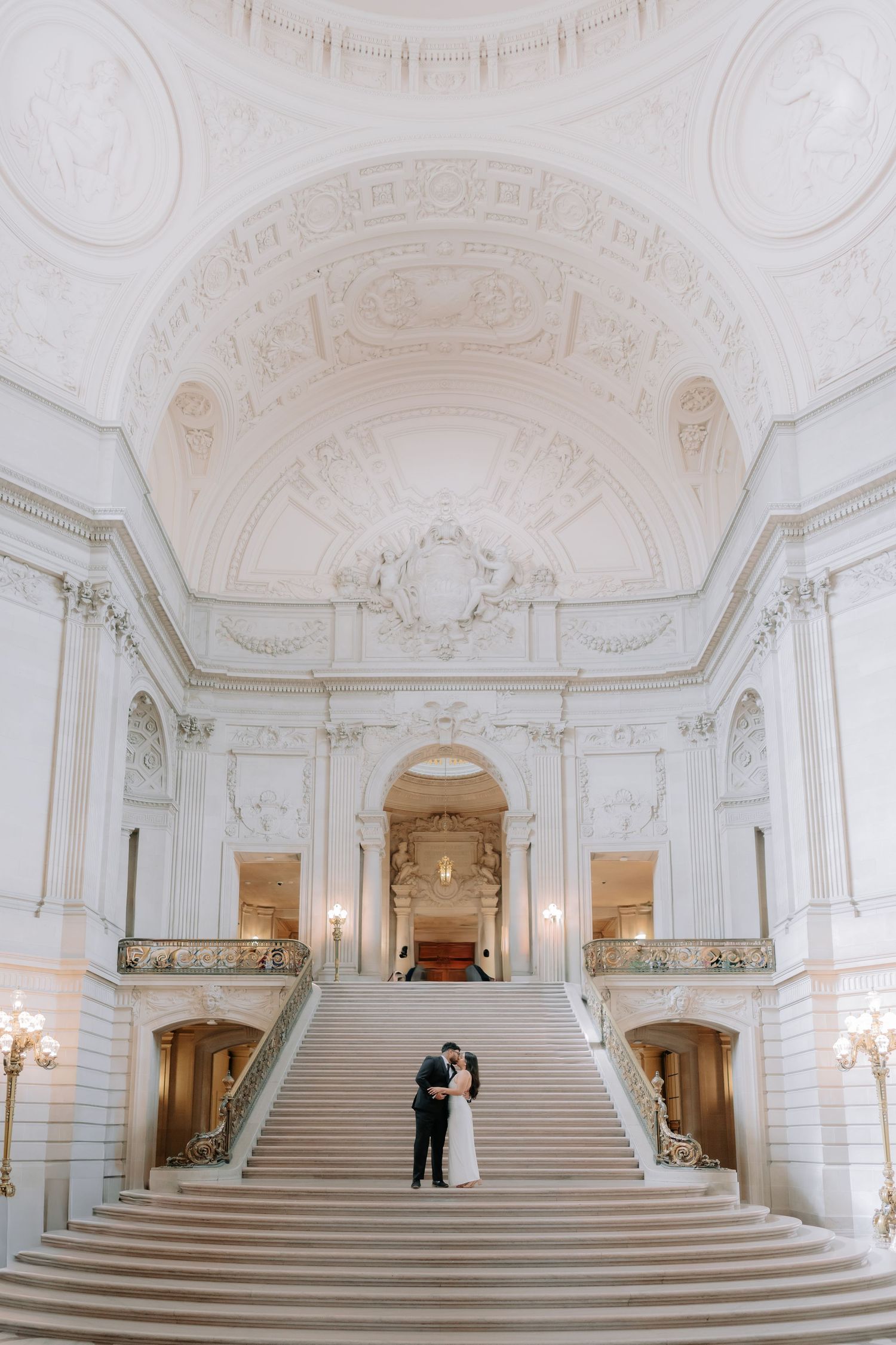 Romantic couple portrait at San Francisco City Hall dome interior