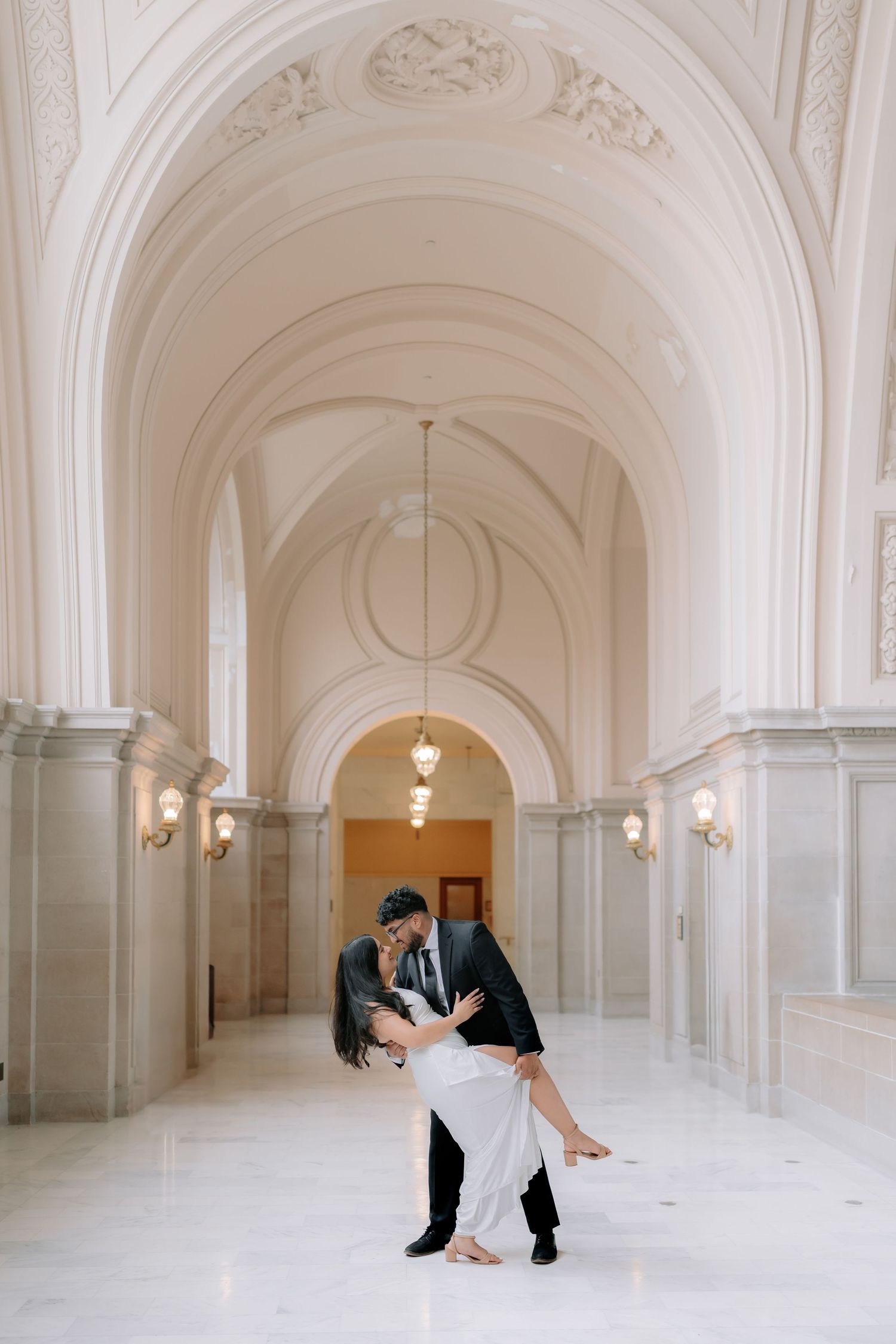 Romantic couple portrait at San Francisco City Hall dome interior