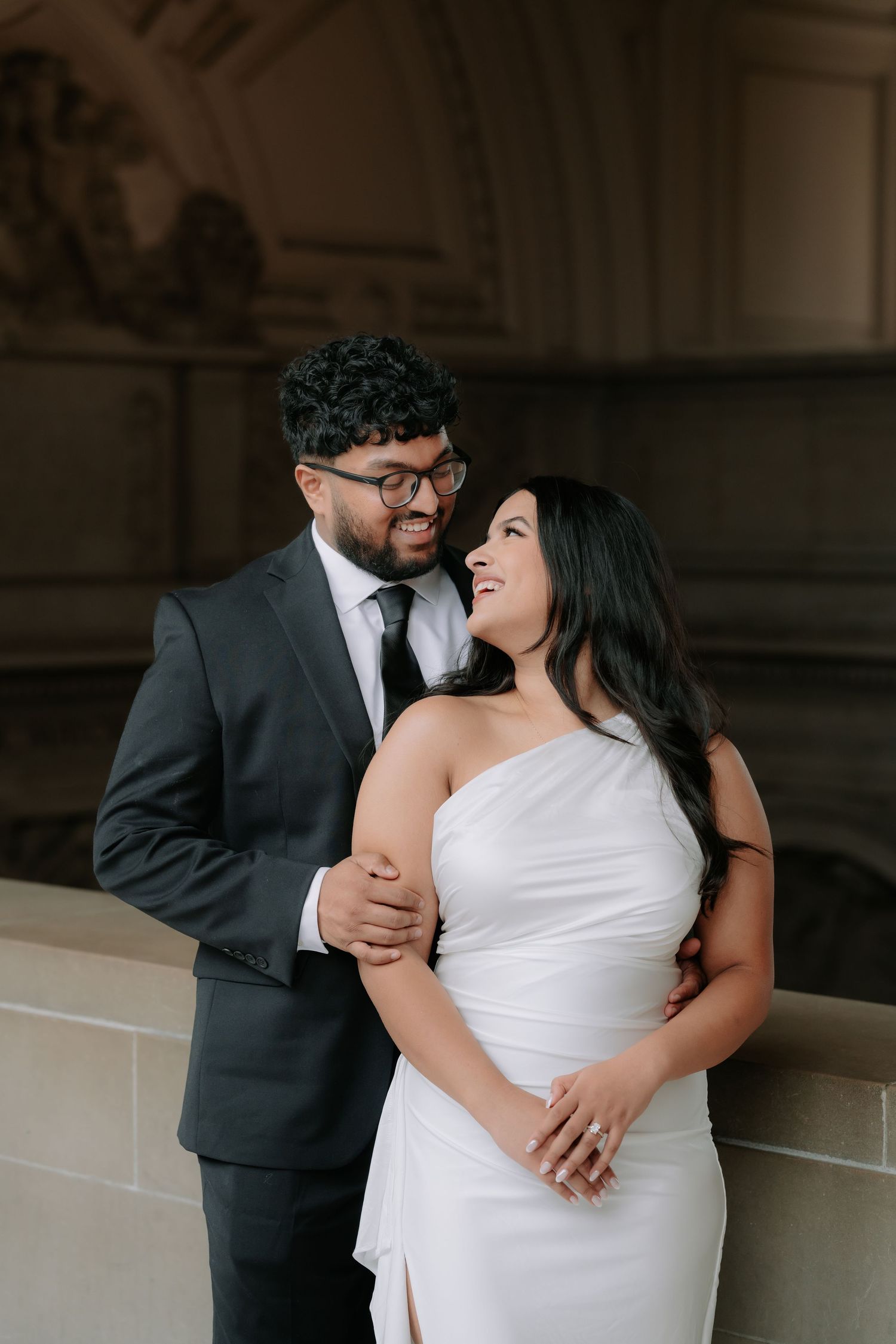 Romantic couple portrait at San Francisco City Hall dome interior