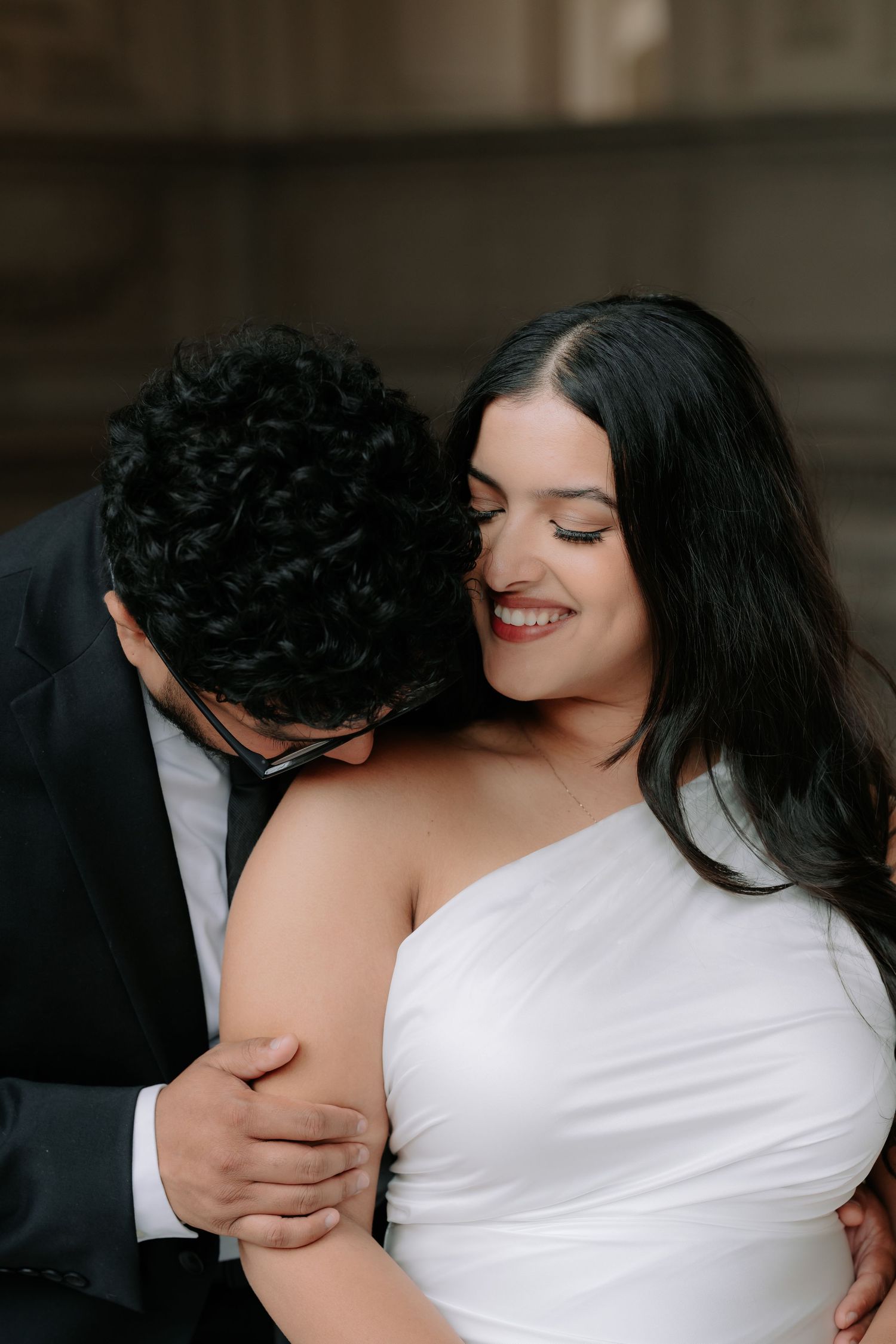 Romantic couple portrait at San Francisco City Hall dome interior