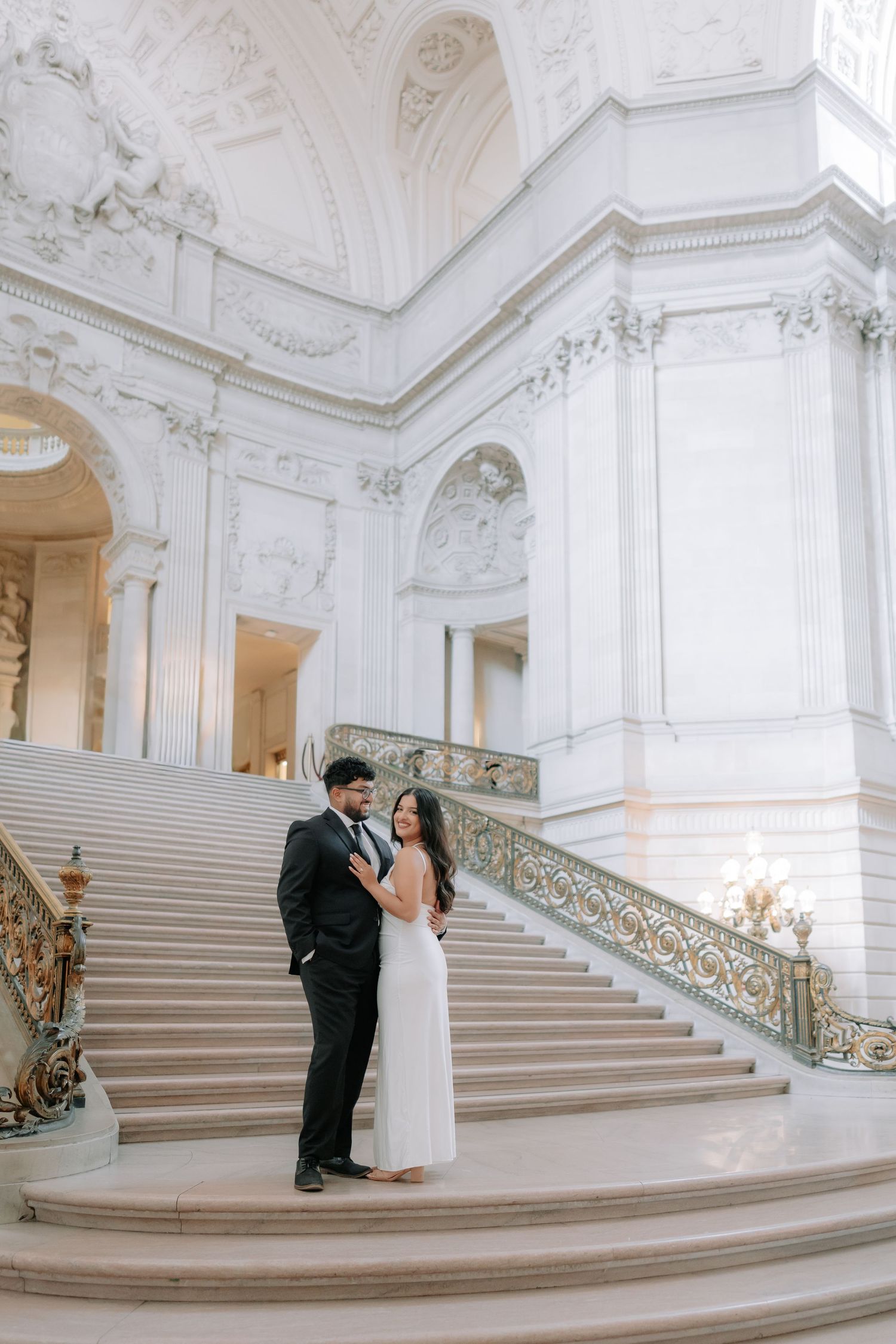 Romantic couple portrait at San Francisco City Hall dome interior