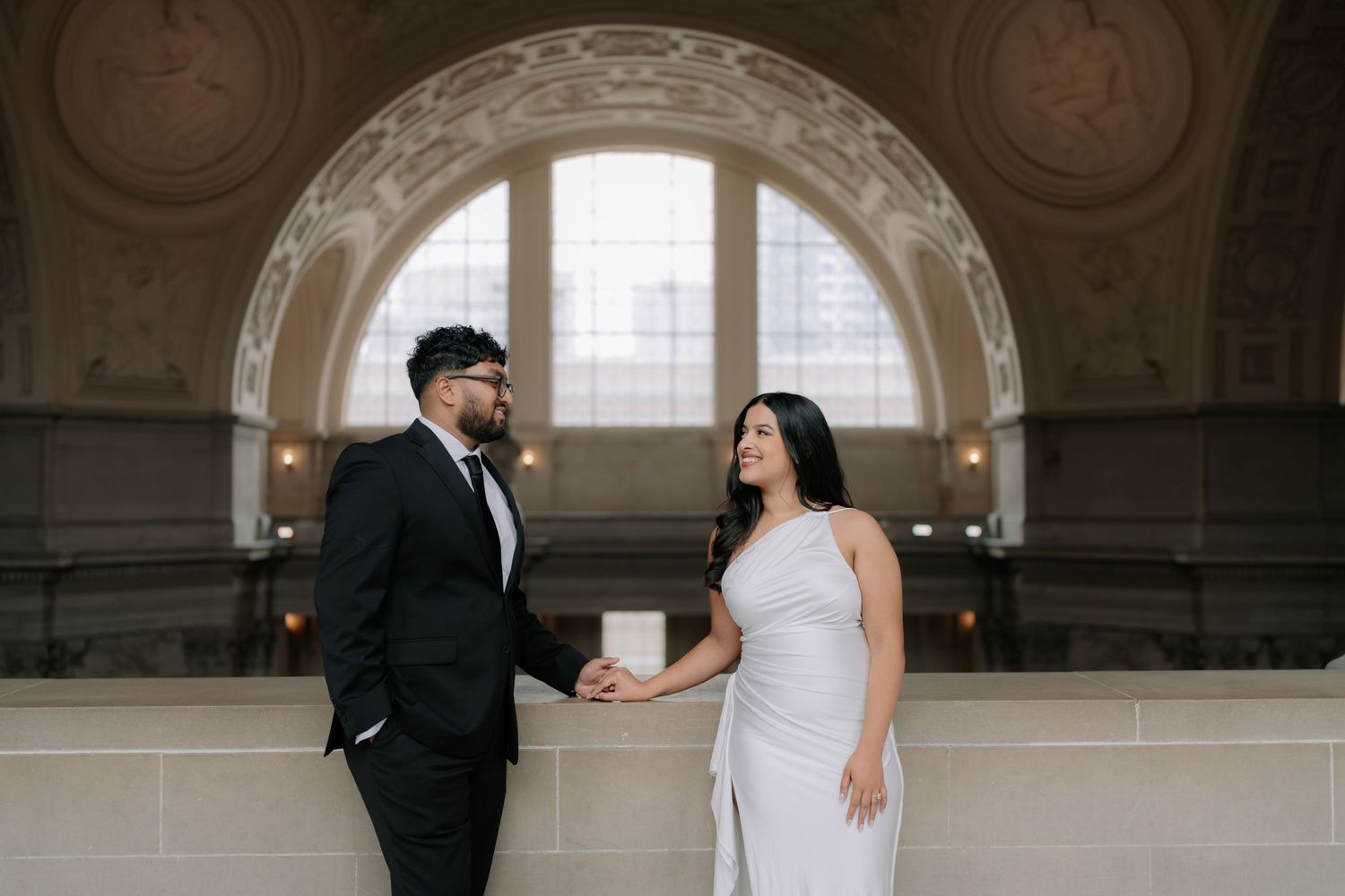 Romantic couple portrait at San Francisco City Hall dome interior