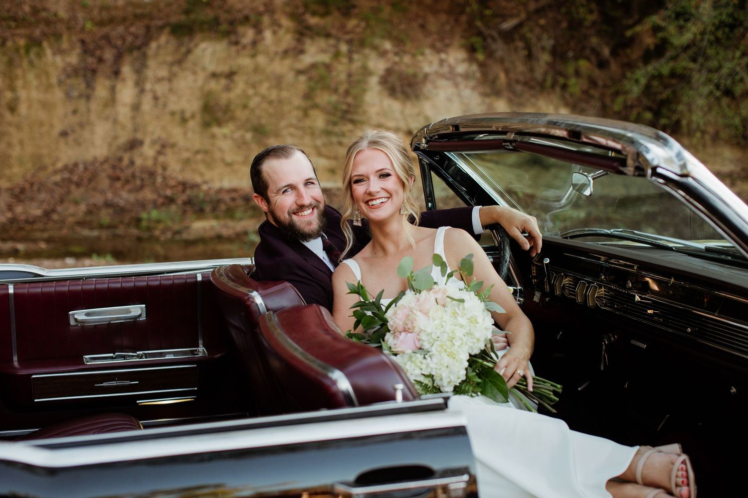 A romantic wedding photo series showing a couple in a vintage car with elegant floral bouquet details.