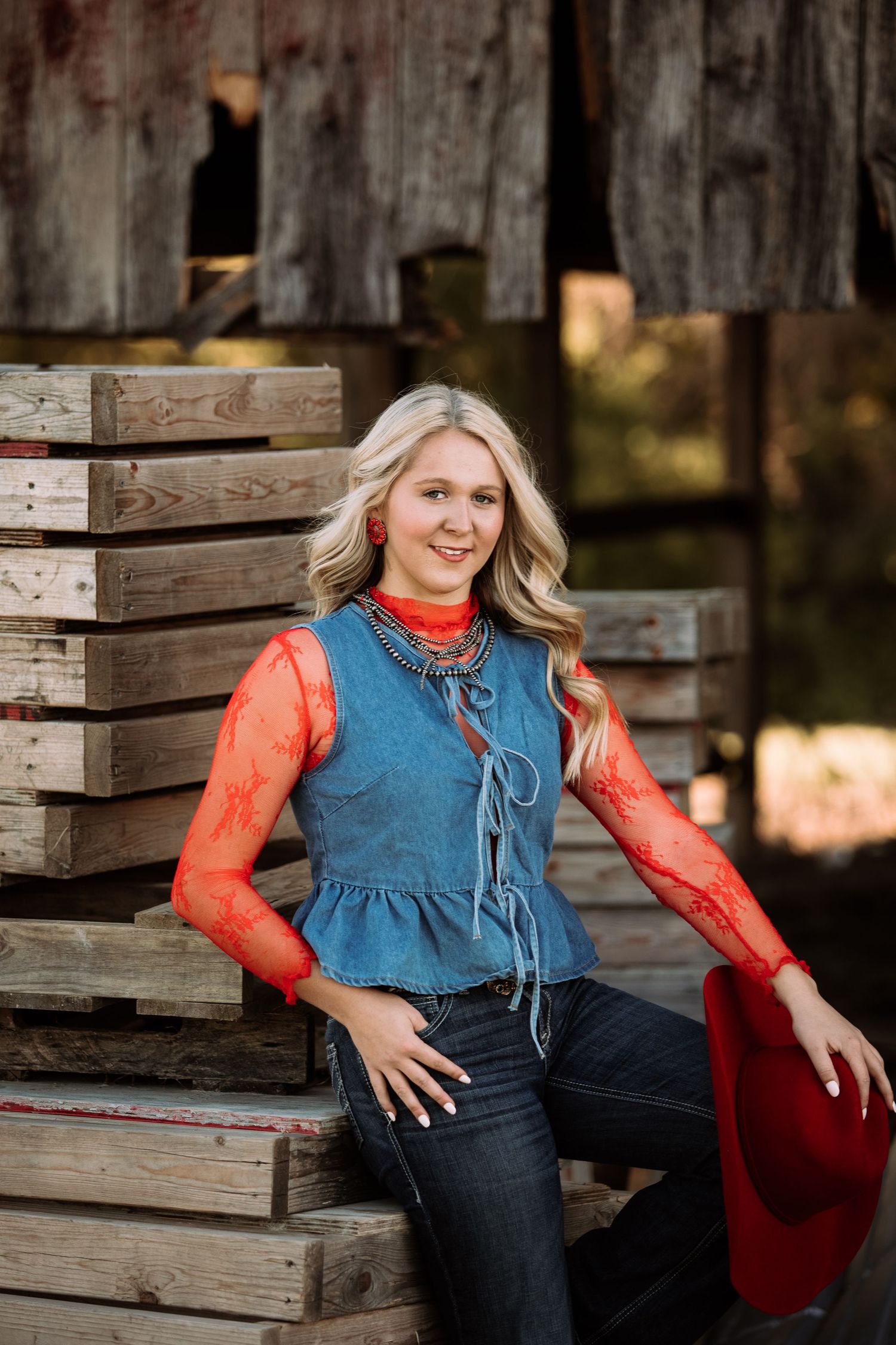 A series of outdoor portraits featuring denim and orange attire against rustic wooden crates and natural scenery.