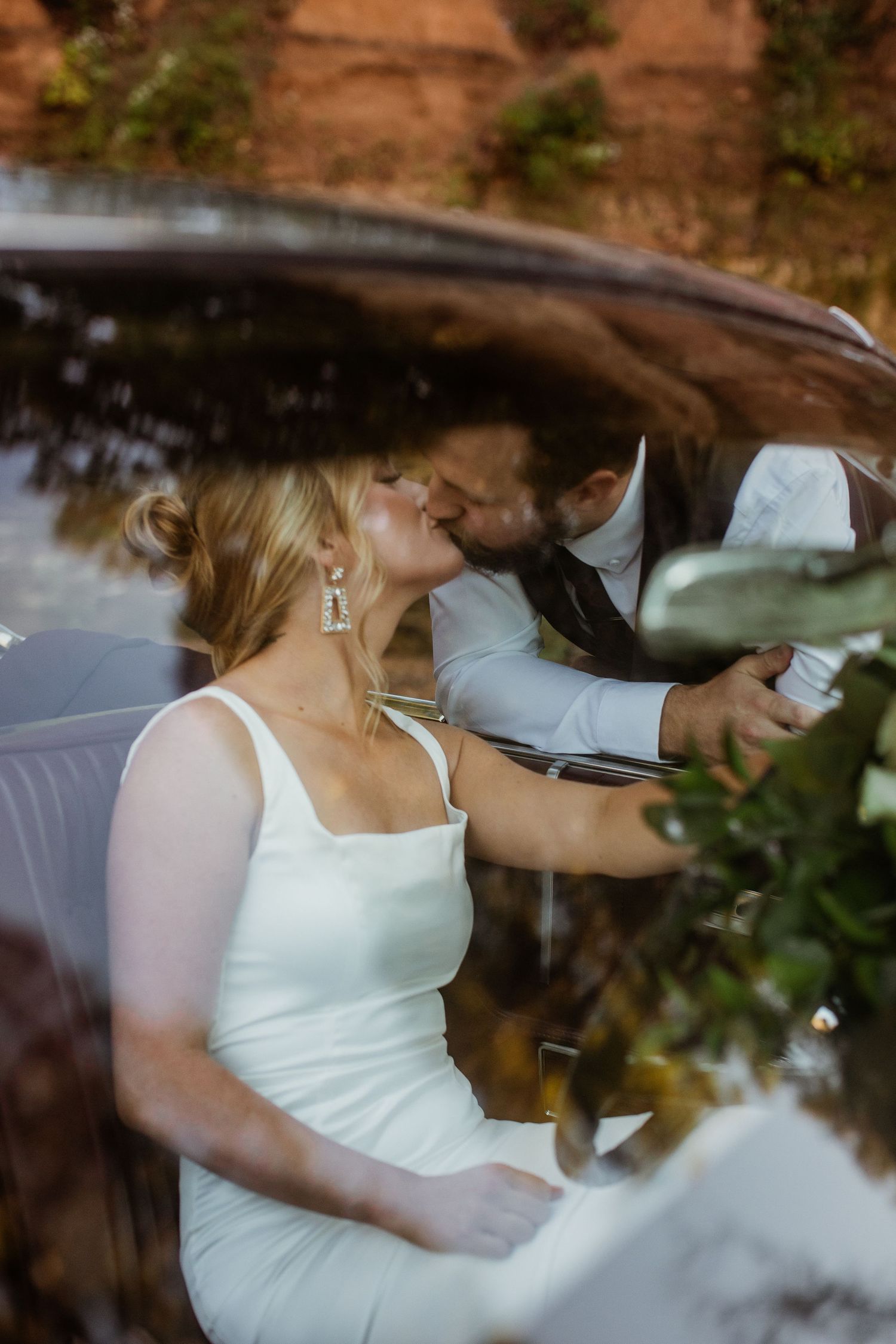 A person in a white dress sits in a car while looking at their phone in a series of connected photos.