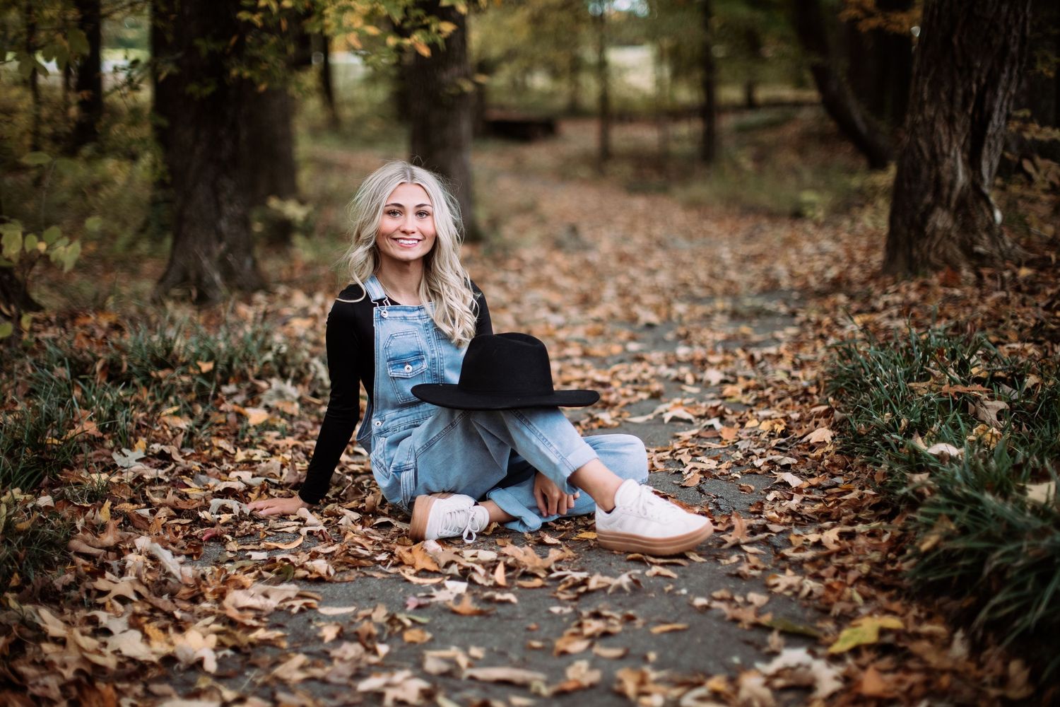 A series of autumn outdoor portraits with someone sitting among fallen leaves in a forest setting.