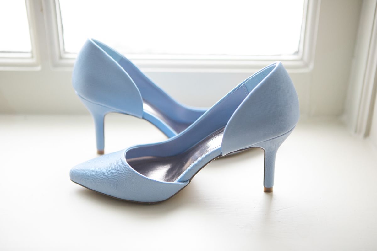 Light blue wedding heels arranged artistically against a white background.