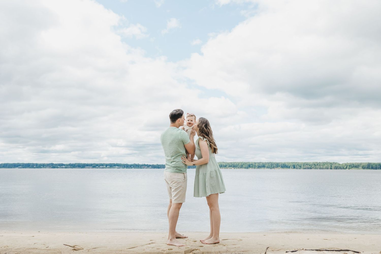 A romantic beach photoshoot at sunset with soft pastel colors and ocean views.