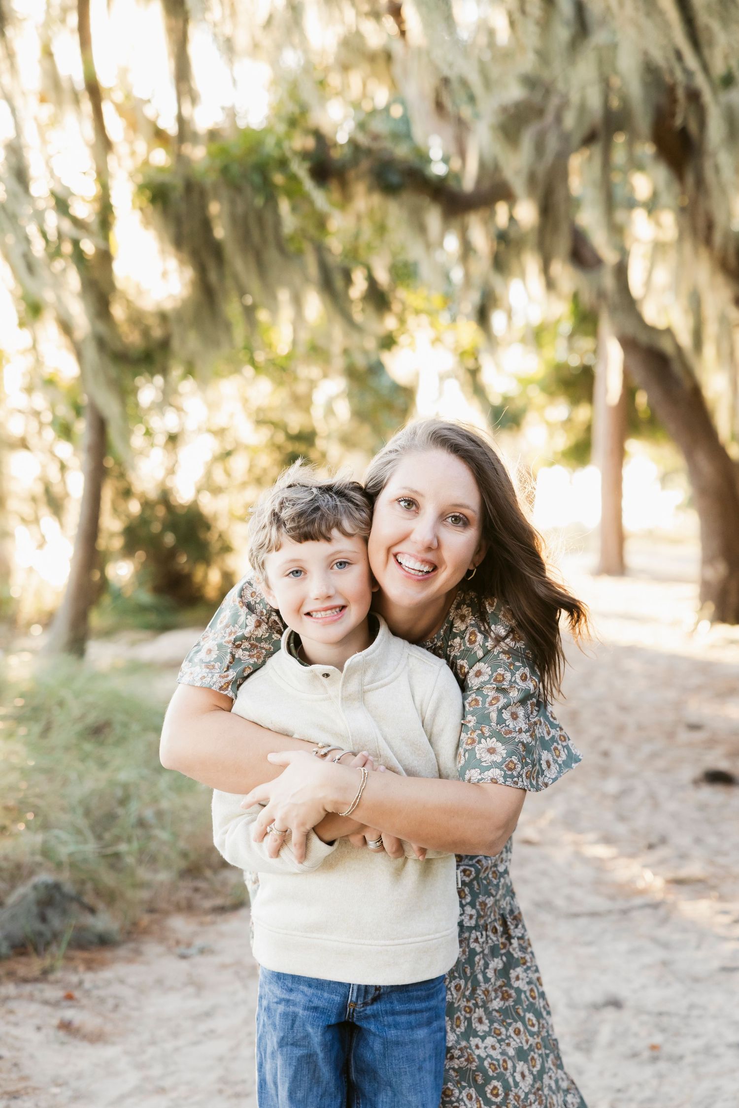 Candid outdoor portrait session among Spanish moss draped trees.