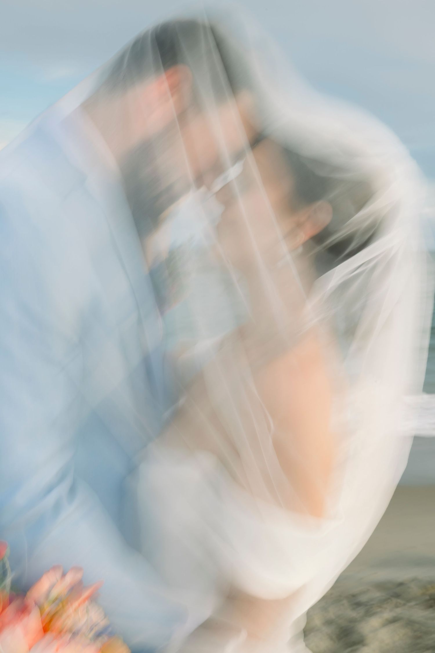 Abstract motion blur photography in soft blue and white tones on the beach.