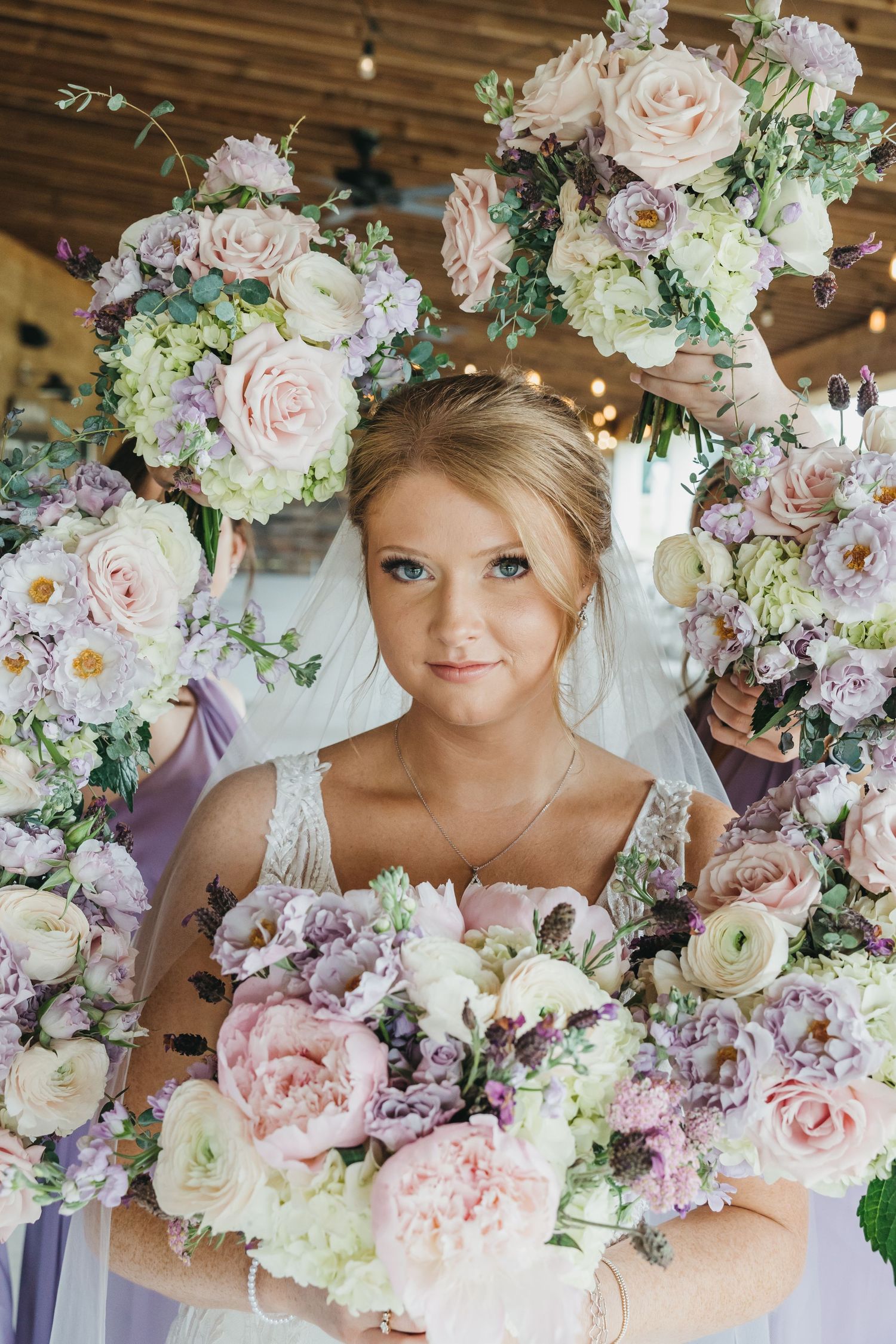 Delicate pink and white floral arrangements create romantic wedding backdrop.