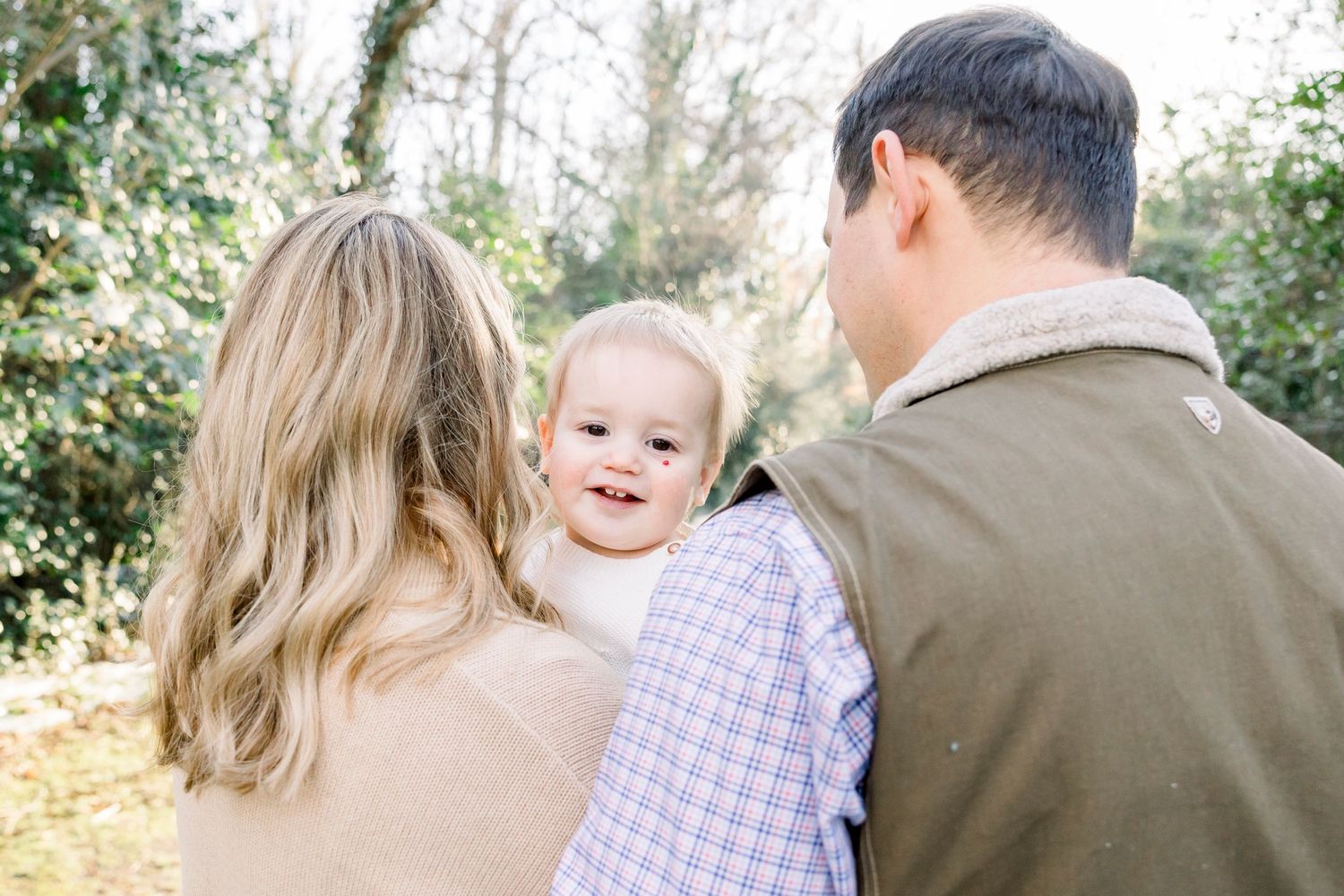 Family members share intimate moments outdoors during a photo session.