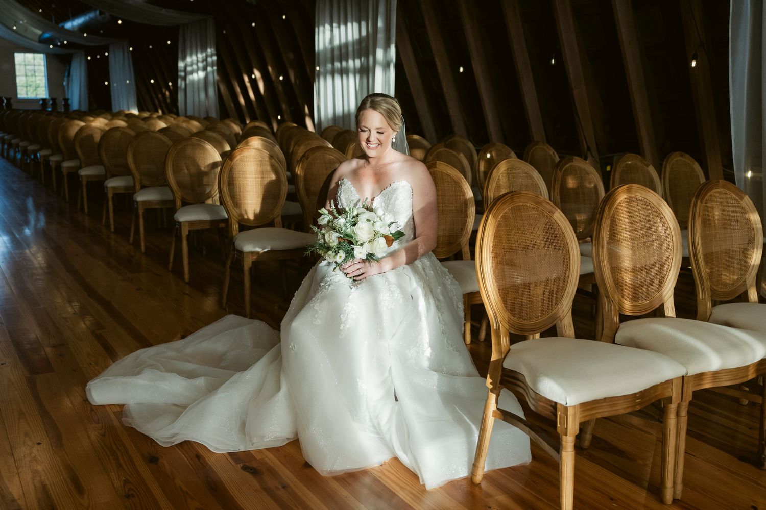 Elegant wedding venue with rows of gold chairs and dramatic lighting.