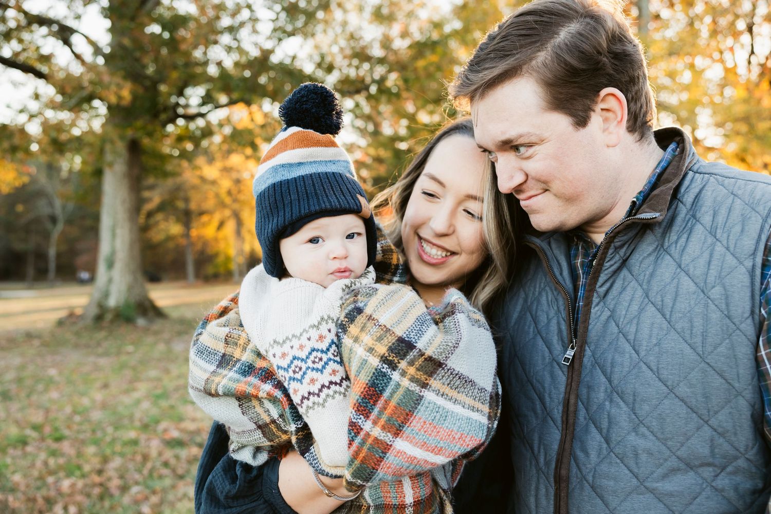 Cozy autumn family photos taken in a field with warm evening light.