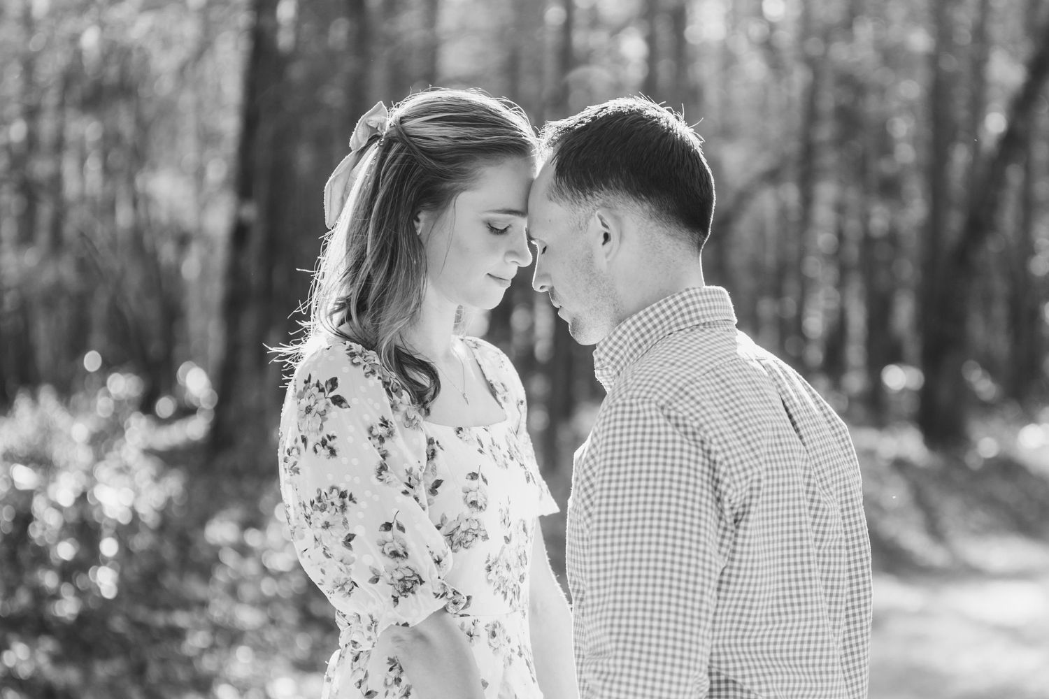 Black and white portraits captured in a serene forest setting.