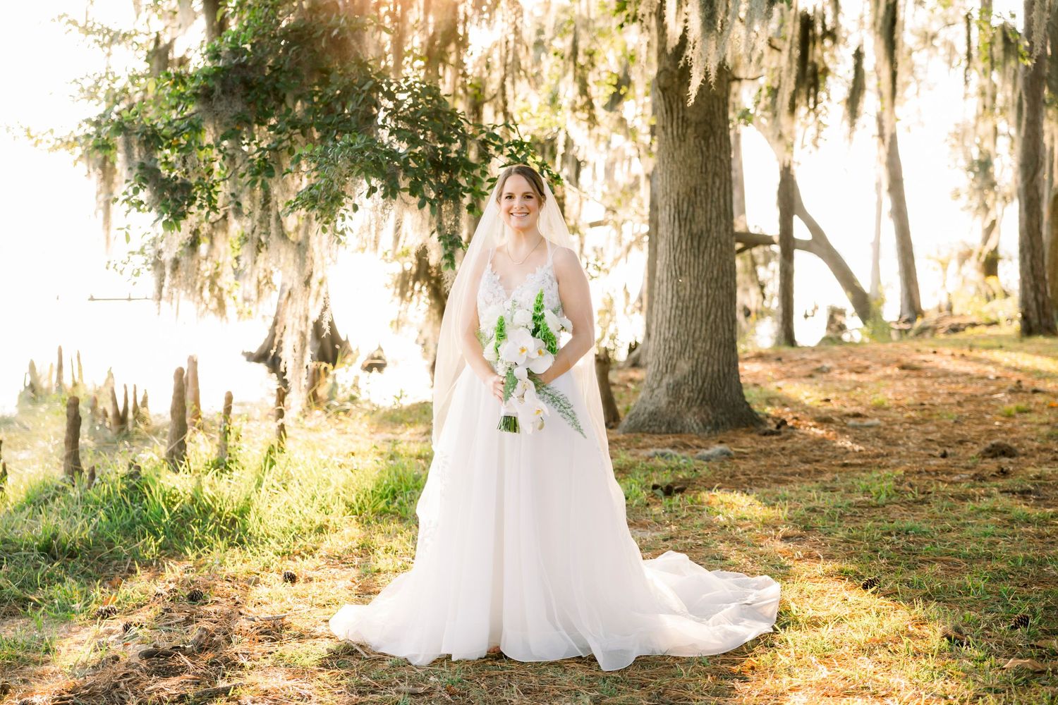 Spanish moss hangs from oak trees creating a dreamy backdrop for bridal portraits.