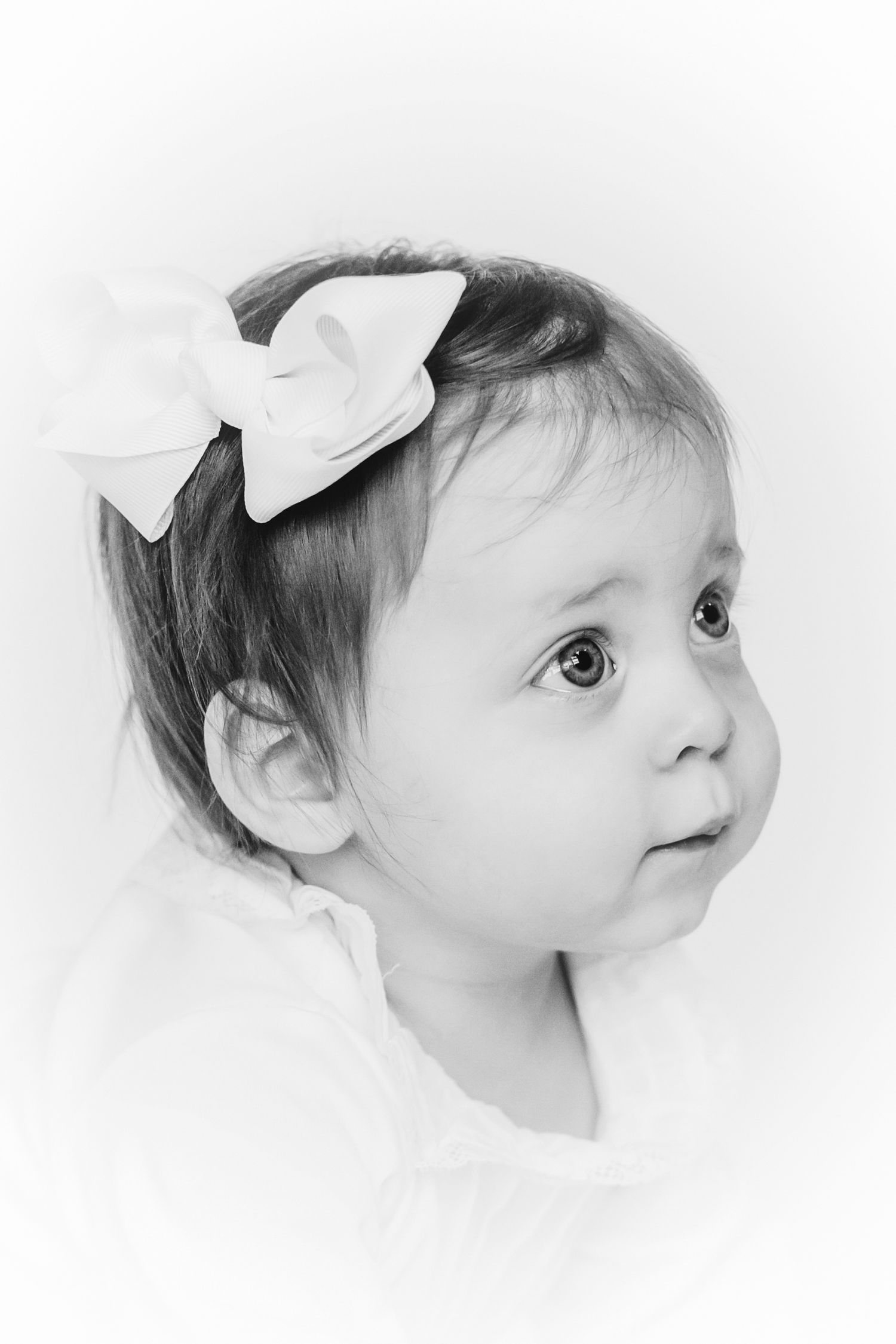 Dreamy black and white side profile portraits with delicate lighting.